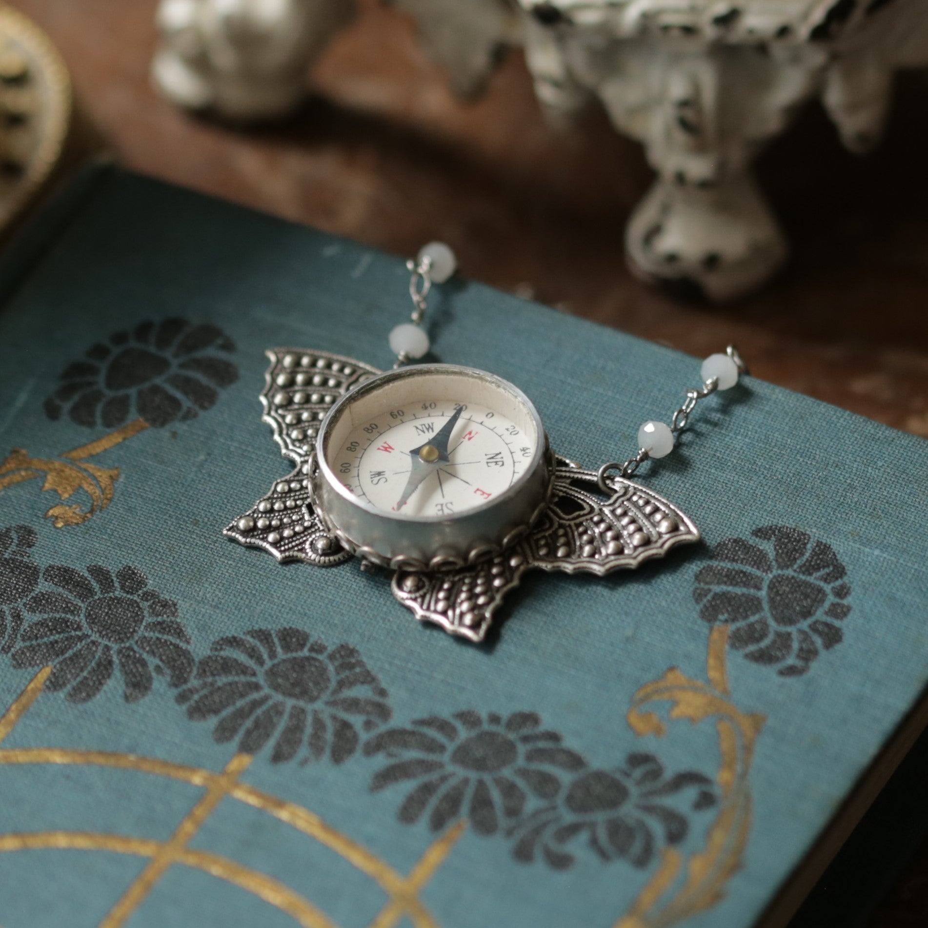 Butterfly Filigree Compass Short Necklace in Antique Silver with Translucent White Beads