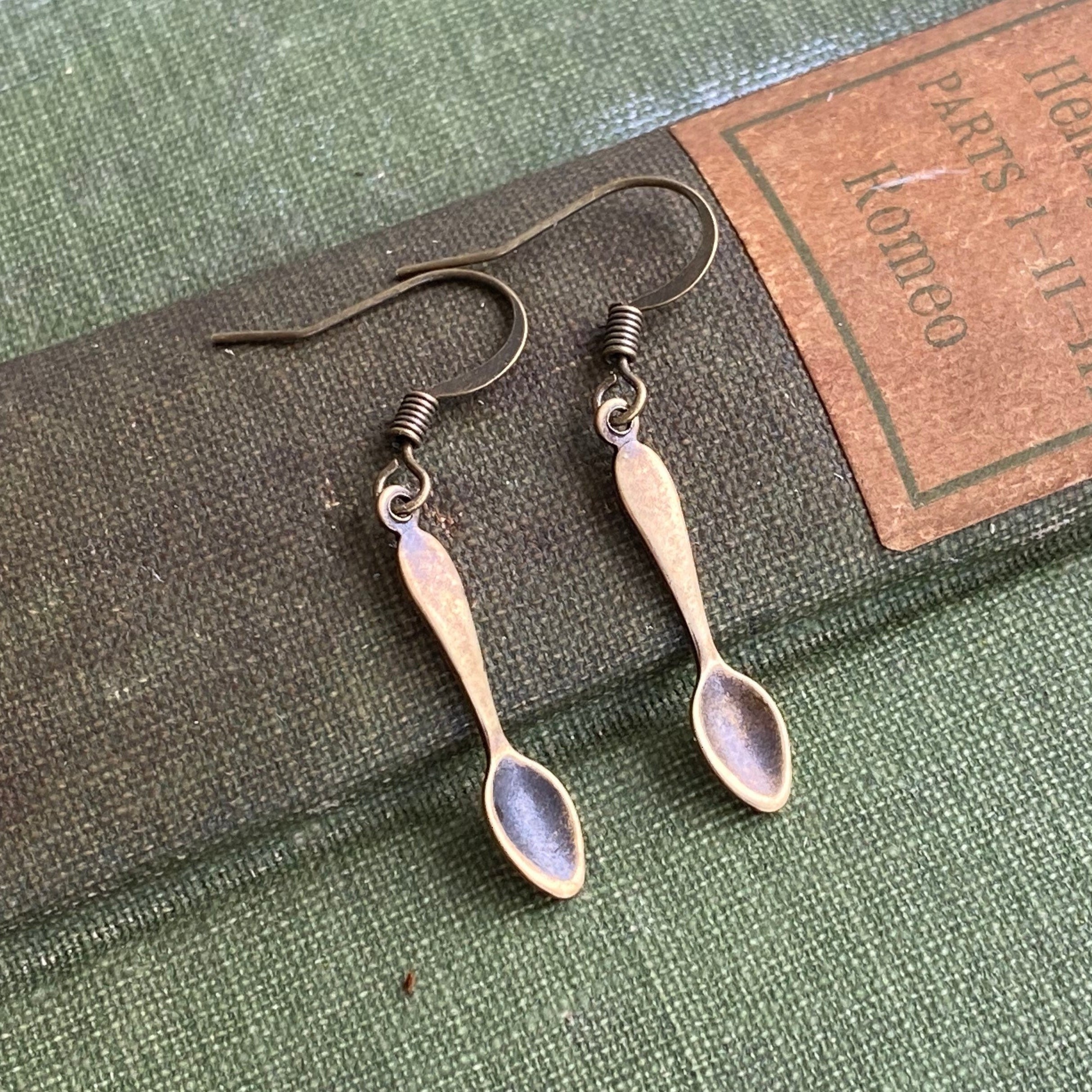 A pair of brass teaspoon dangle earrings.