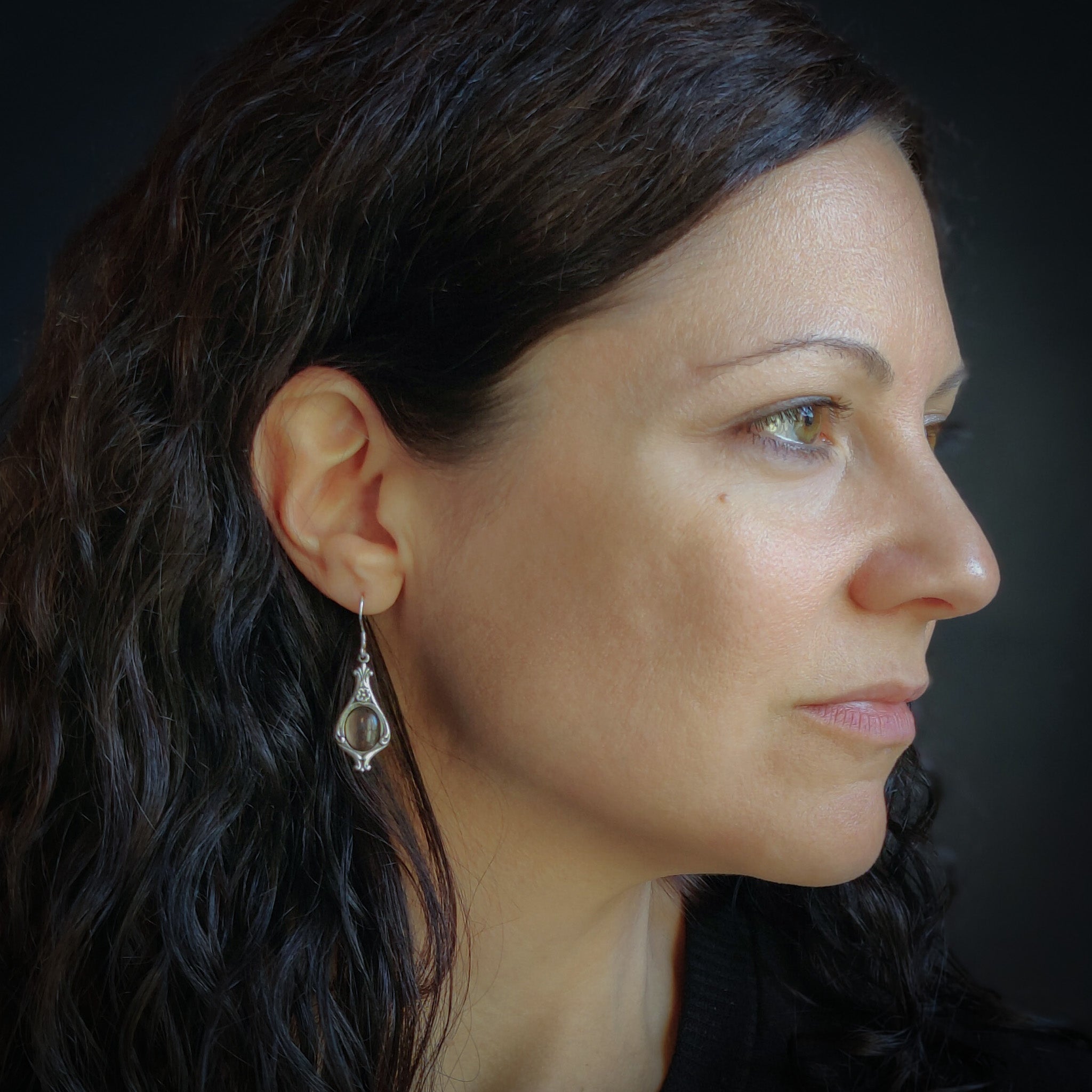 A pair of silver Victorian drop earrings with gray shell cabochons.
