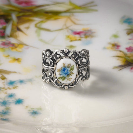 Antiqued silver vintage style adjustable filigree ring with an antique blue rose porcelain cameo.