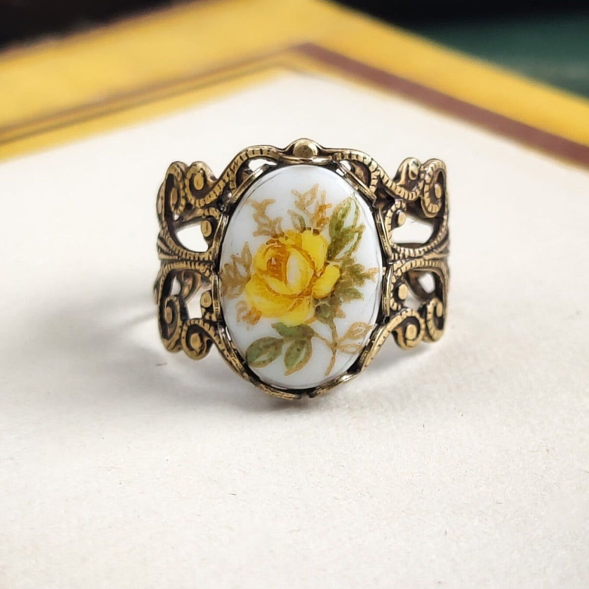 Antiqued brass filigree adjustable ring with an antique porcelain yellow rose cameo