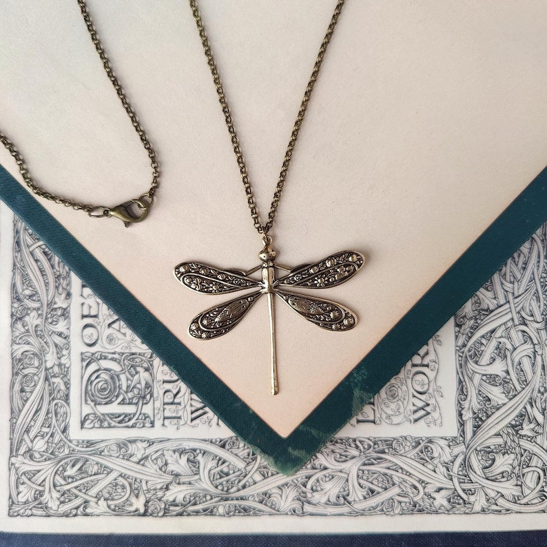 Antiqued brass dragonfly pendant on a simple chain.