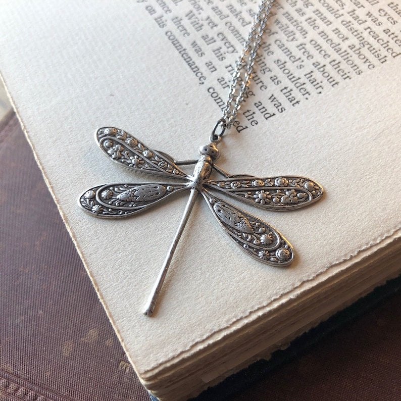 Antiqued silver dragonfly pendant on a simple chain.