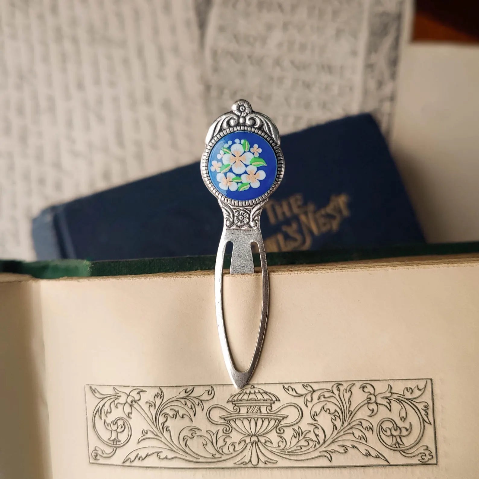 antiqued silver modern vintage inspired bookmark clip page saver with a circle metal blue flower motif a perfect gift for a book club.