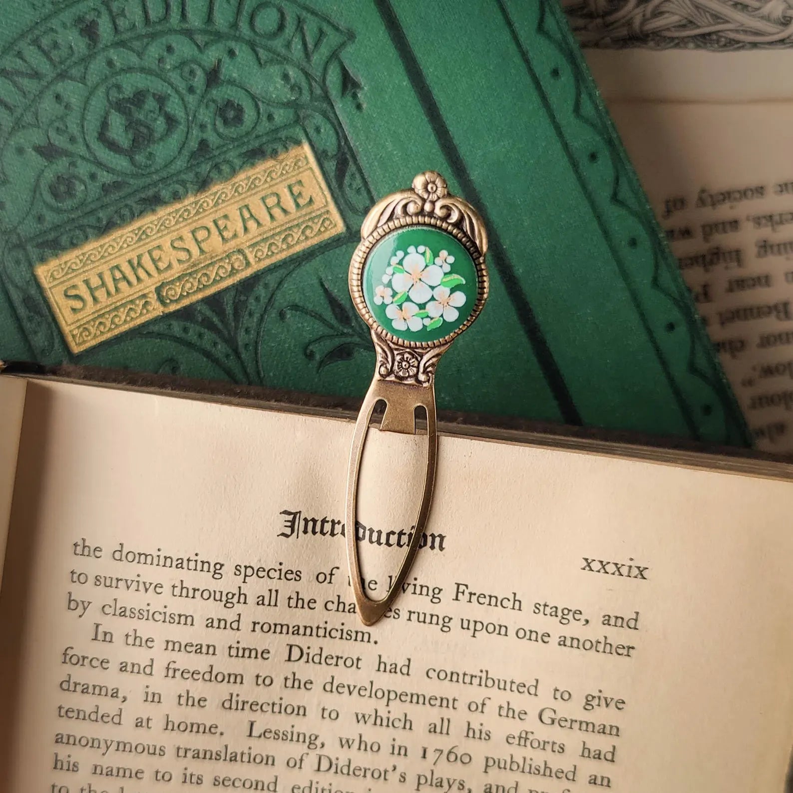 antiqued brass modern vintage inspired bookmark clip page saver with a circle metal green flower motif a perfect gift for a book lover.