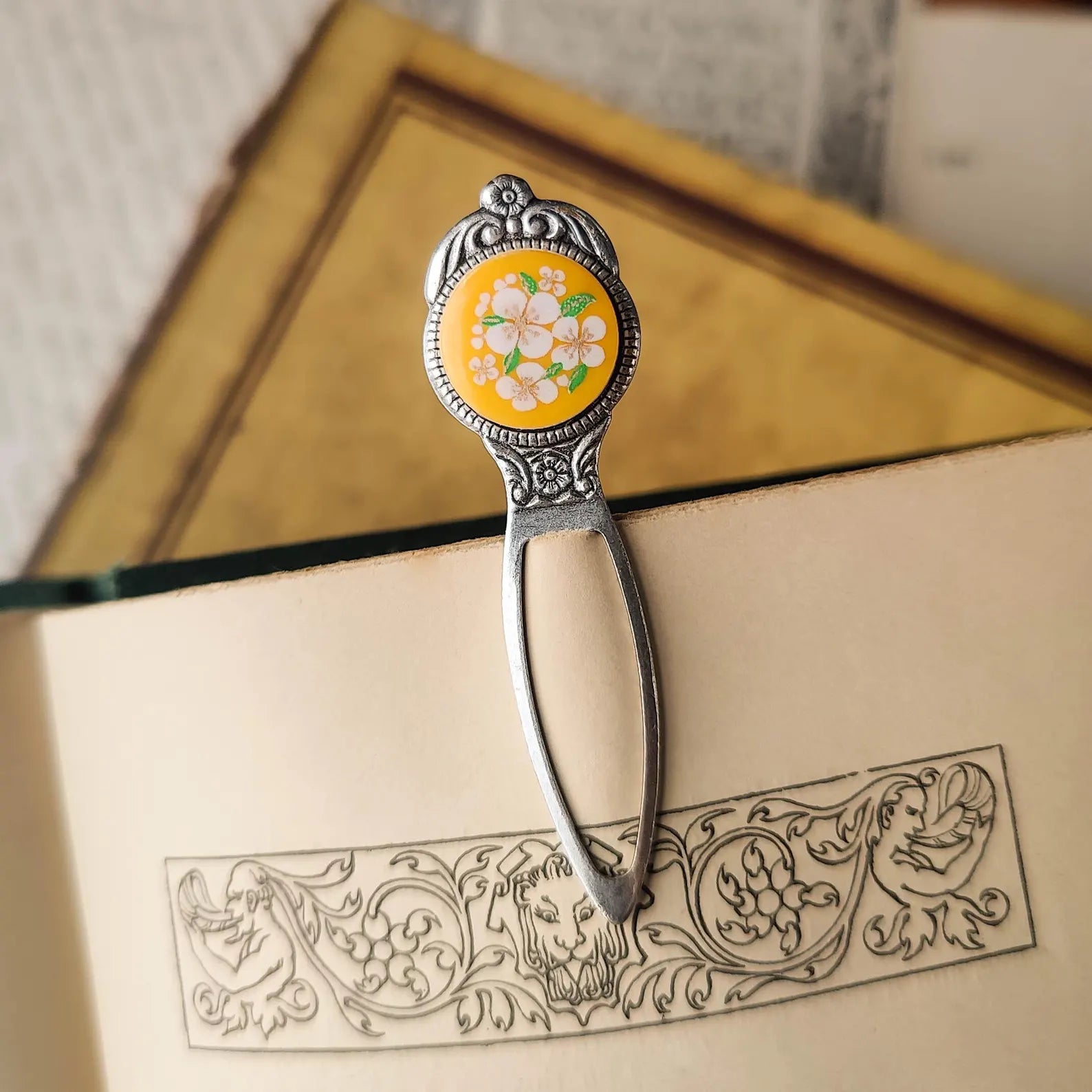 antiqued silver modern vintage inspired bookmark clip page saver with a circle metal yellow flower motif a perfect gift for a bibliophile.