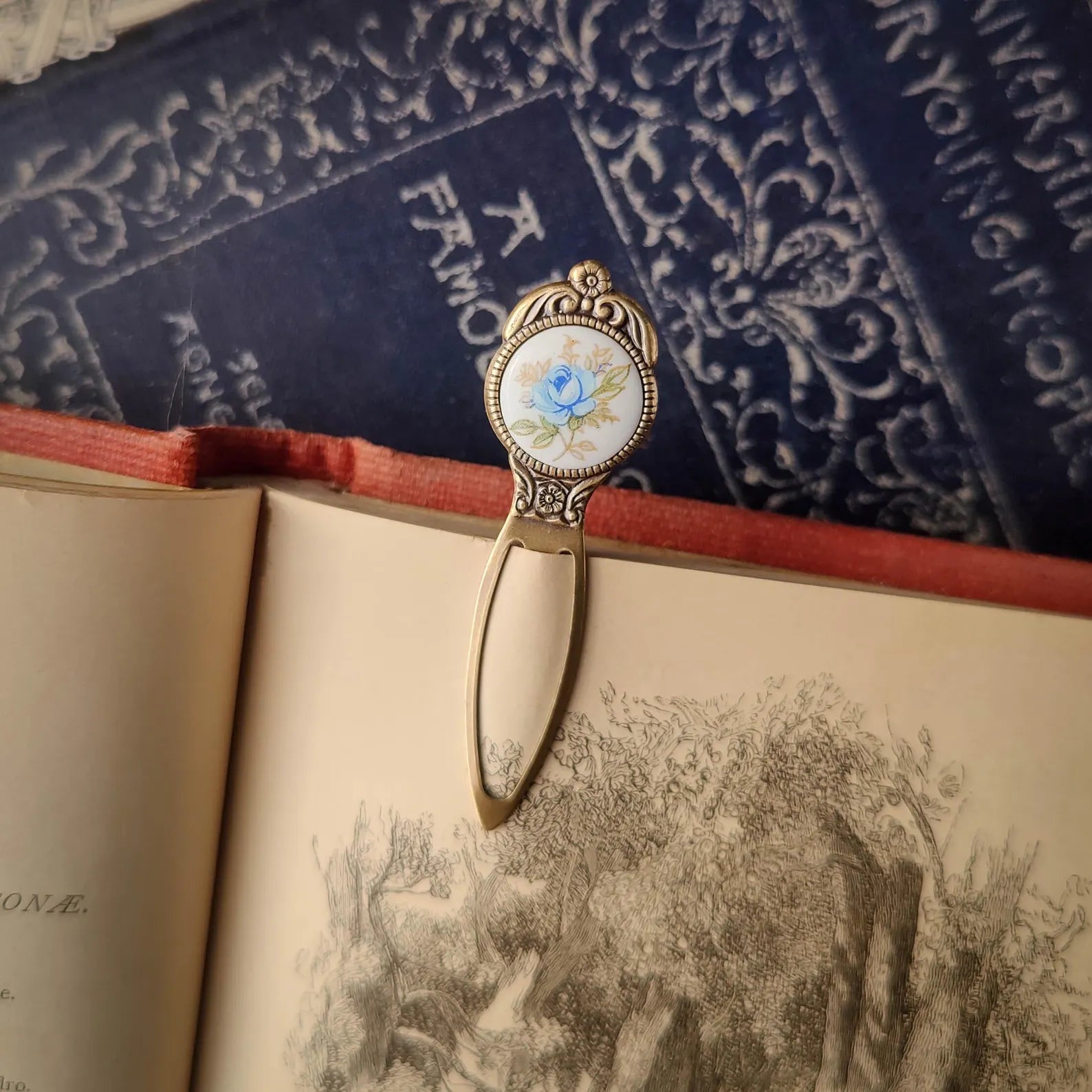 antiqued brass modern vintage inspired blue rose cabochon circle bookmark. Great gift for bookworm.