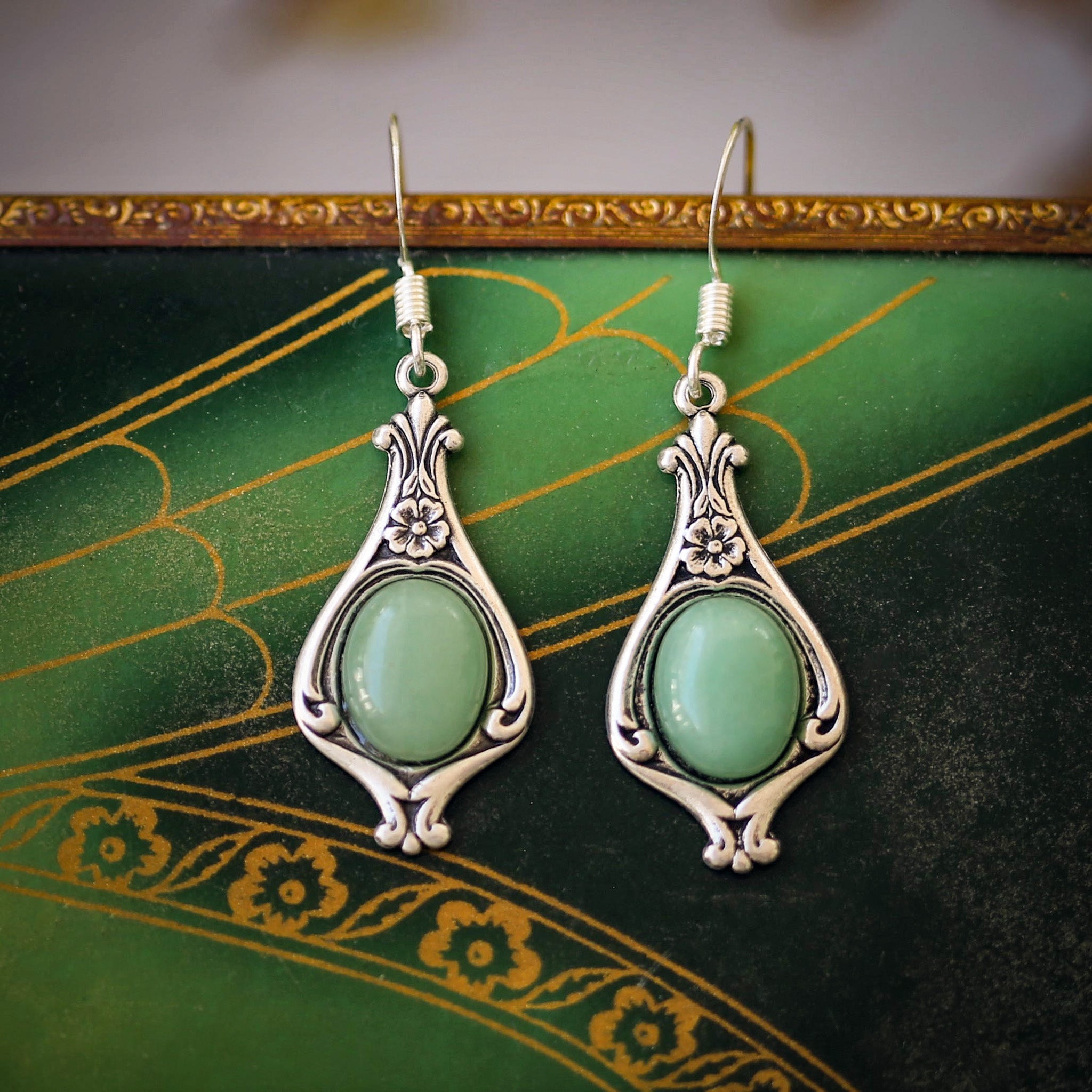 A pair of silver Victorian drop earrings with aventurine gemstones.