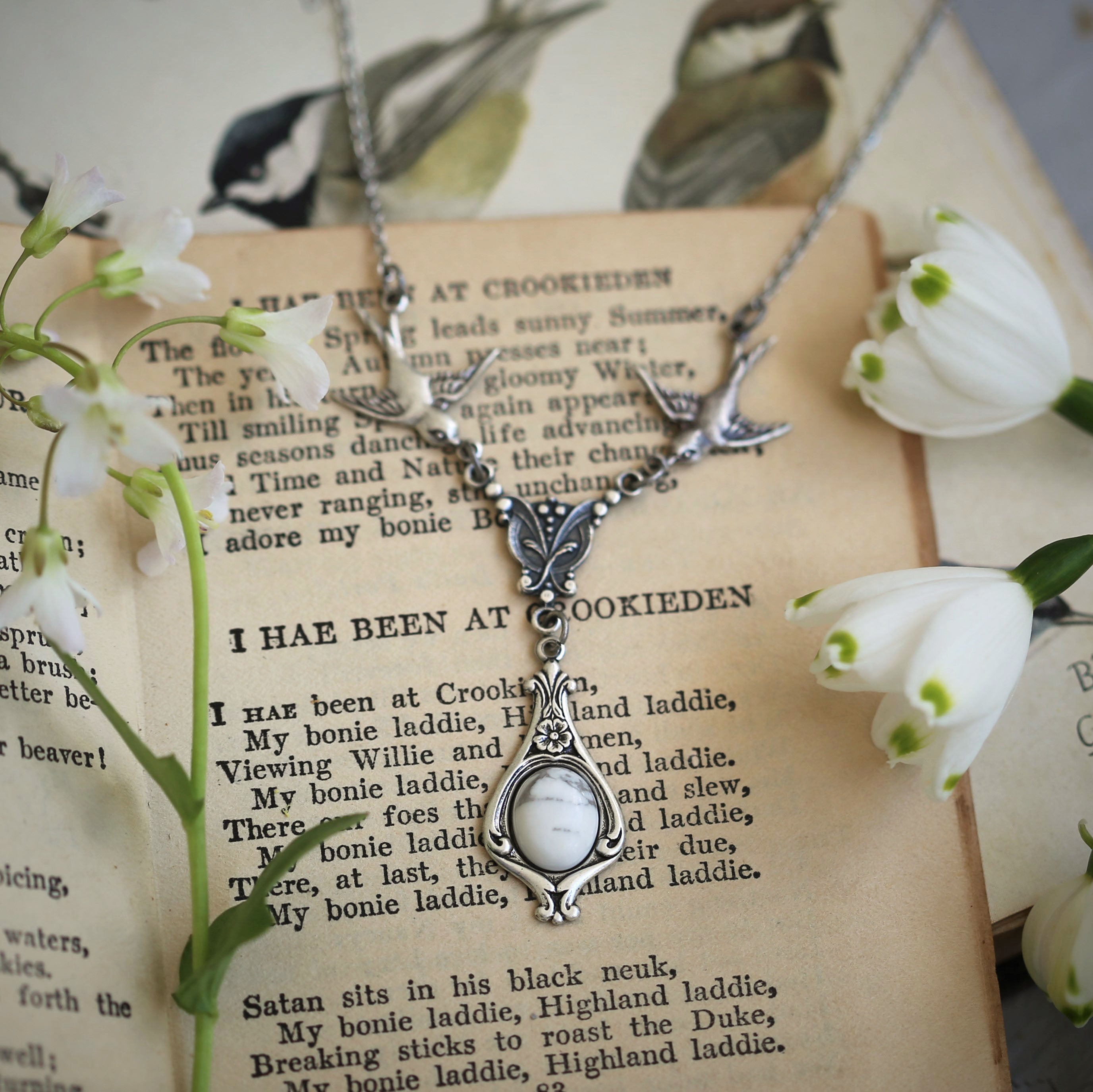 Silver vintage-style necklace with two birds and a white howlite drop