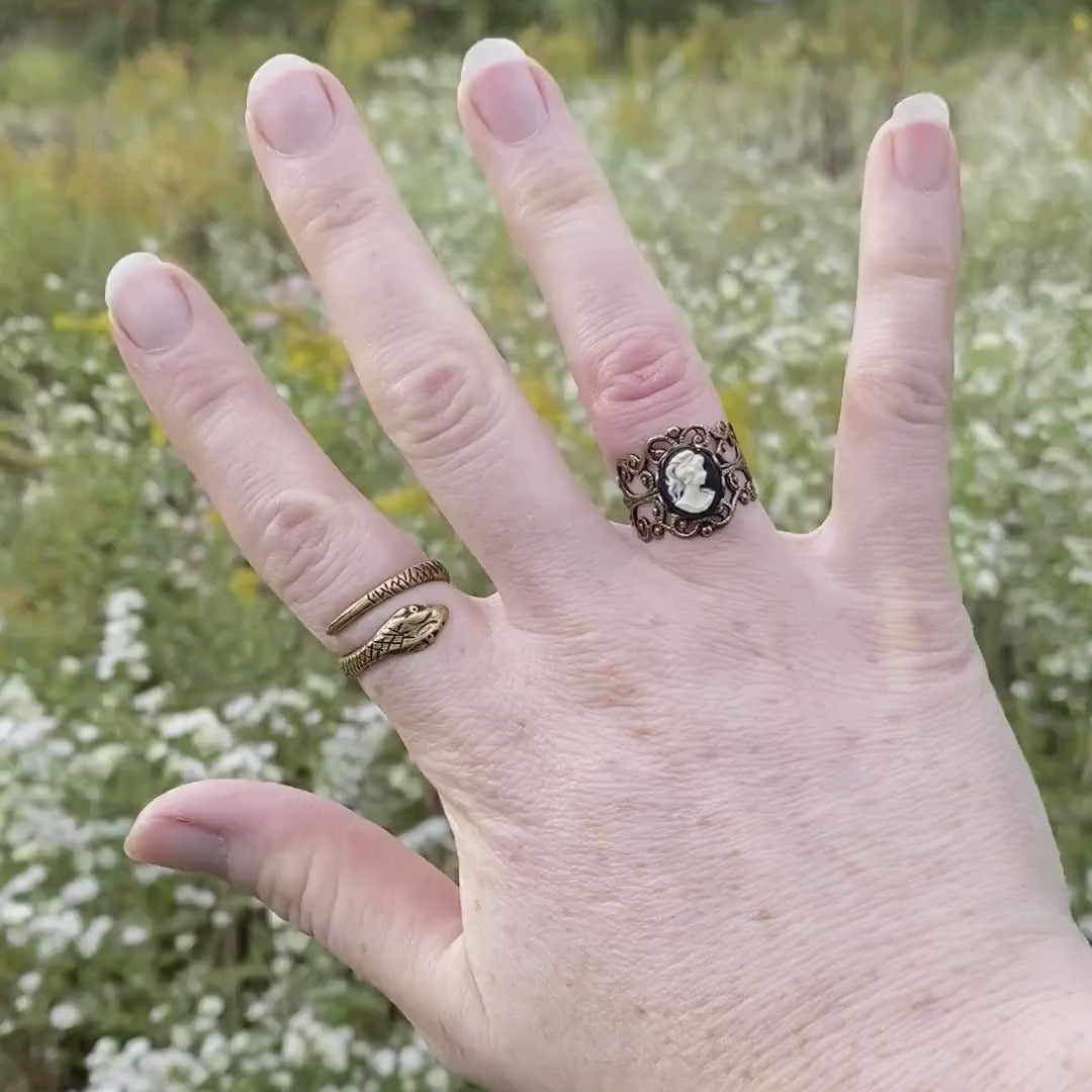 A video of a model wearing an antiqued brass cameo ring.