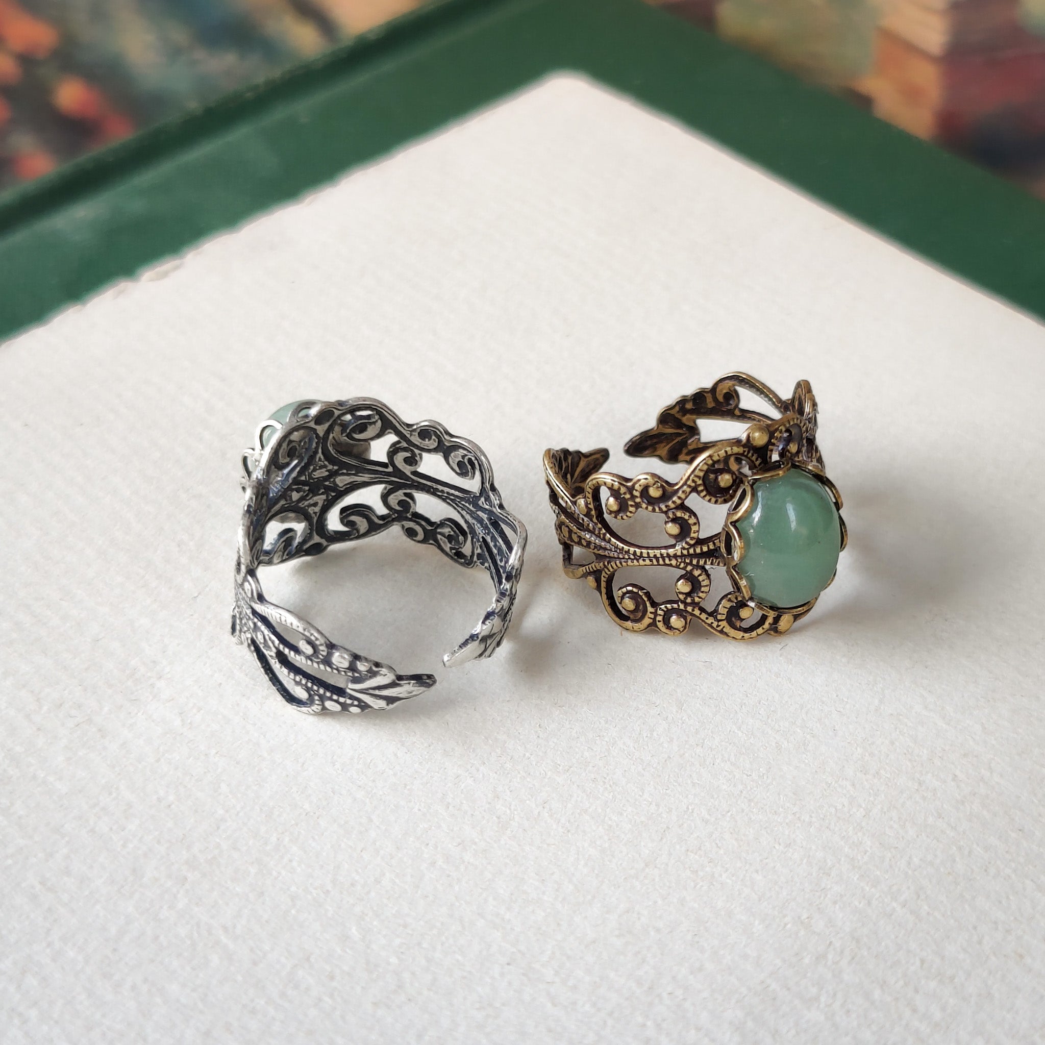 Antiqued brass and silver modern vintage inspired adjustable filigree cocktail ring with a green aventurine semi-precious stone in the bohemian style.