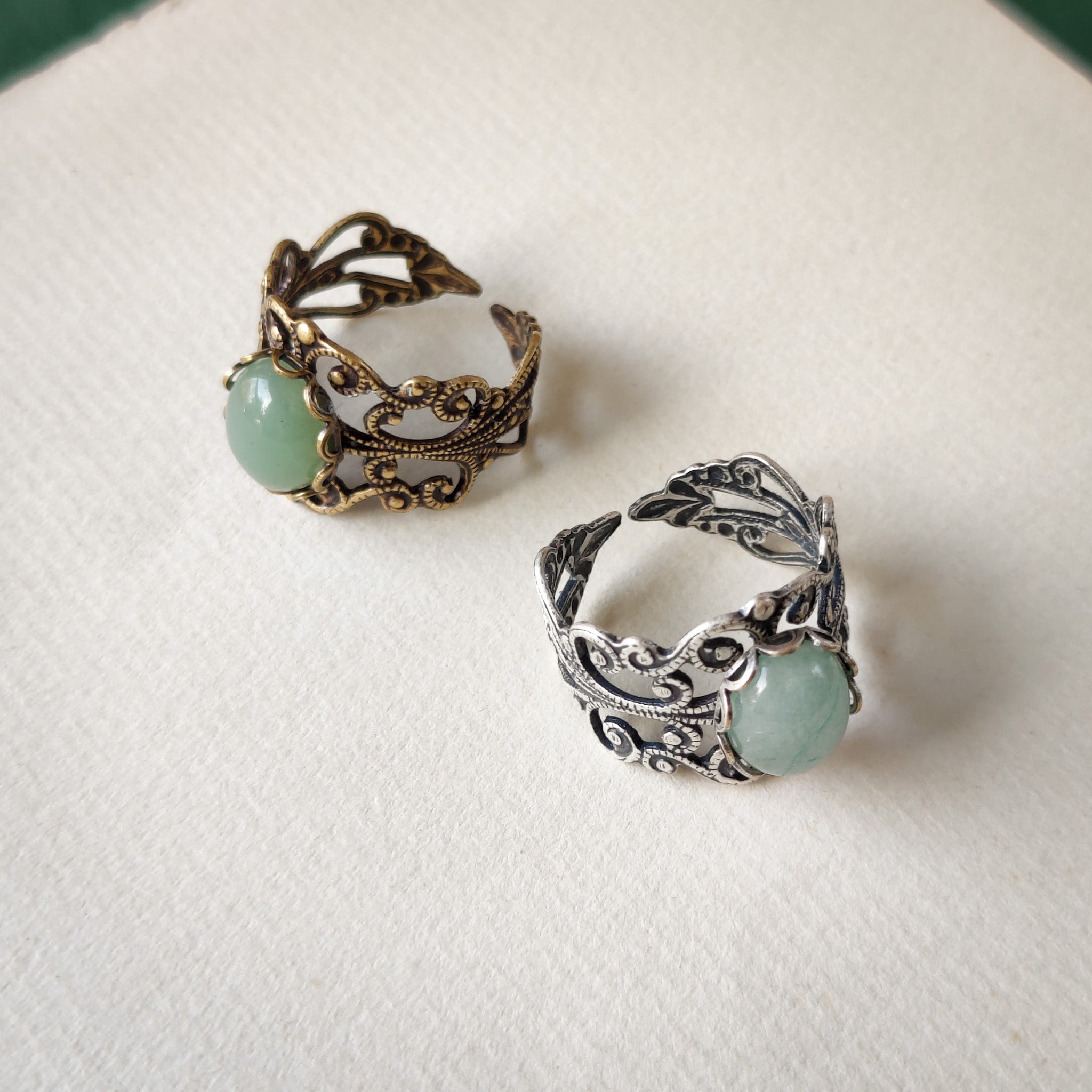 Antiqued brass and silver modern vintage inspired adjustable filigree cocktail ring with a green aventurine semi-precious stone in the boho style.