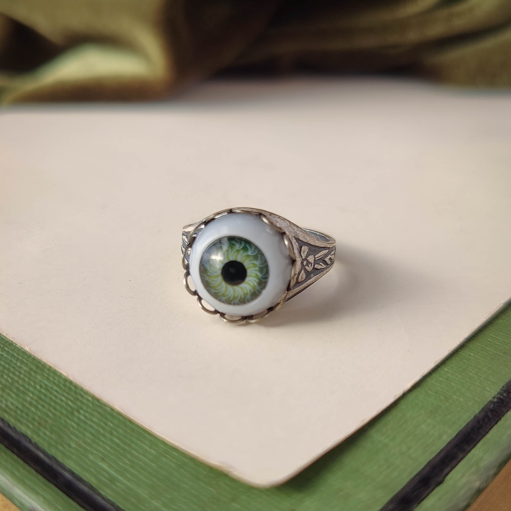 antiqued silver victorian gothic adjustable green witch cocktail ring with a green doll's evil eye.