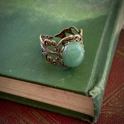 Antiqued brass filigree adjustable ring with oval green aventurine stone by ragtrader vintage.