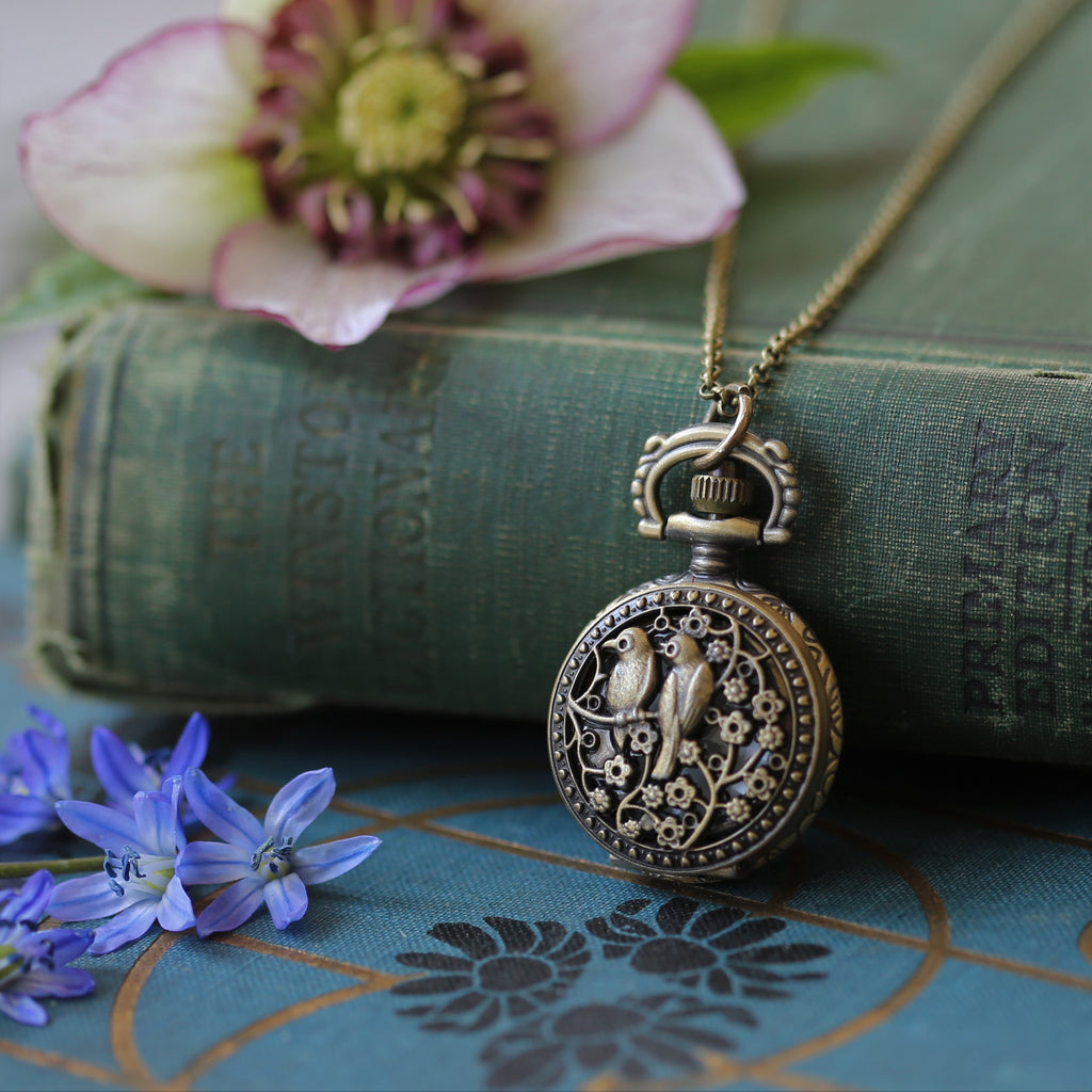 Working watch necklace in antiqued brass with two birds on a cherry branch battery operated pocket watch.