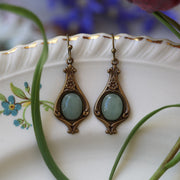 Antiqued brass vintage style dangle hook earrings with green oval aventurine stones.