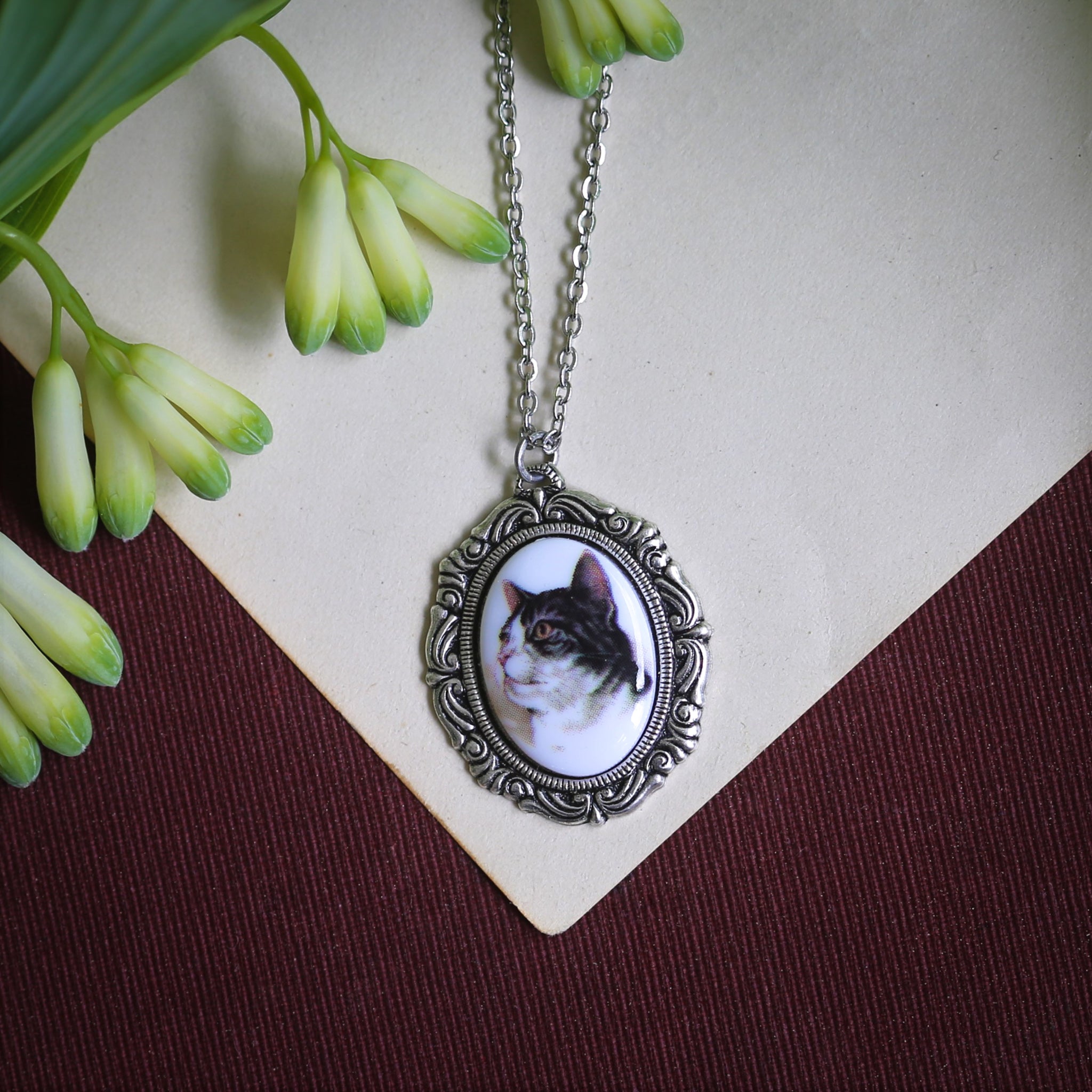 Antiqued silver vintage style necklace with a black and white tabby cat cameo made by ragtrader vintage.