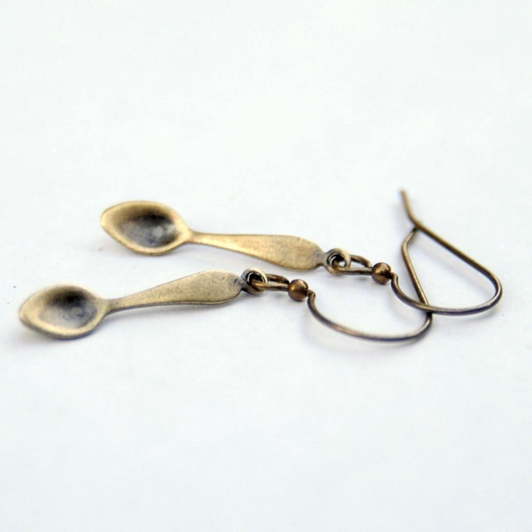 A pair of brass teaspoon dangle earrings.