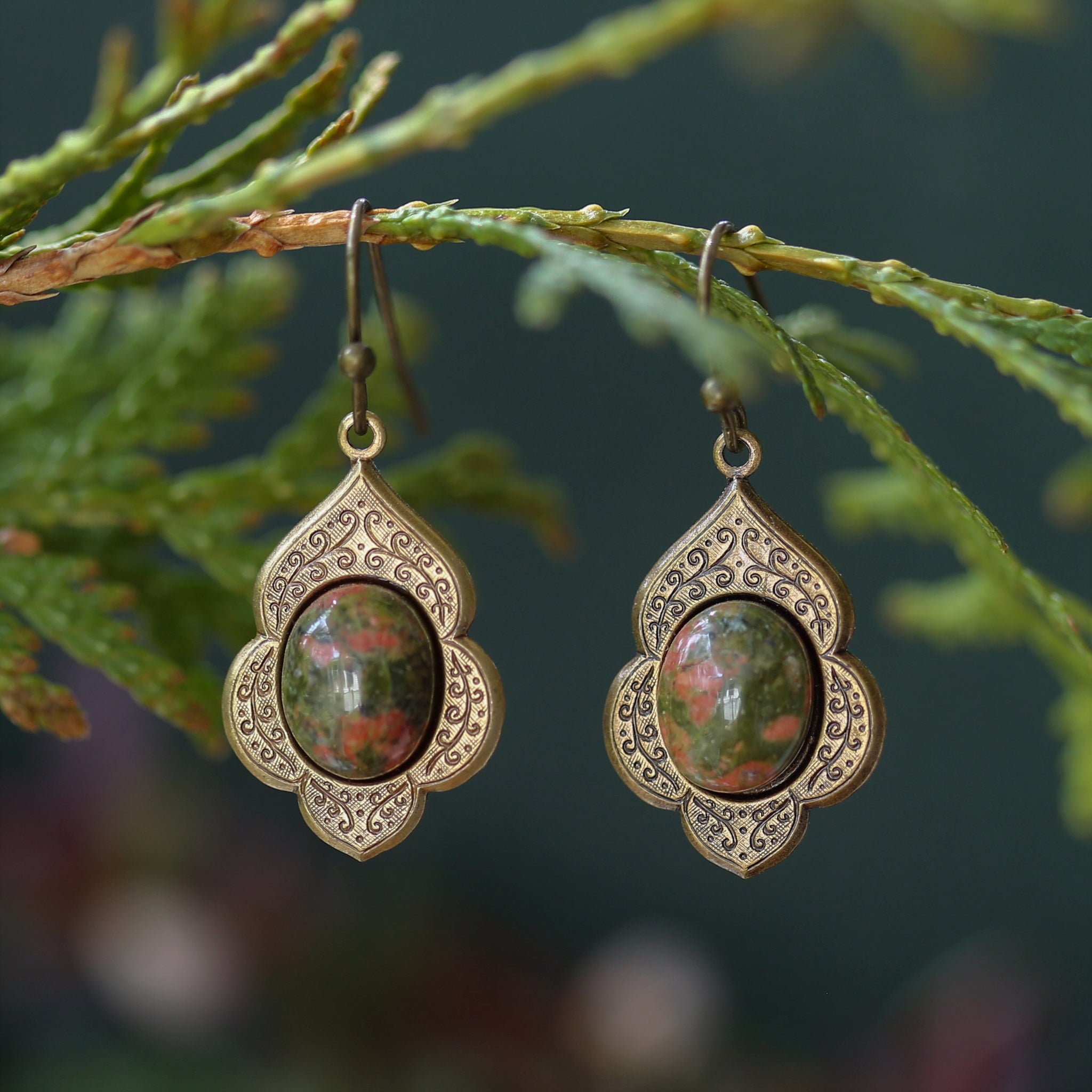 antiqued brass vintage style drop dangle earrings with a leaf and vine motif with semi-precious aventurine mineral oval stone cabochons.
