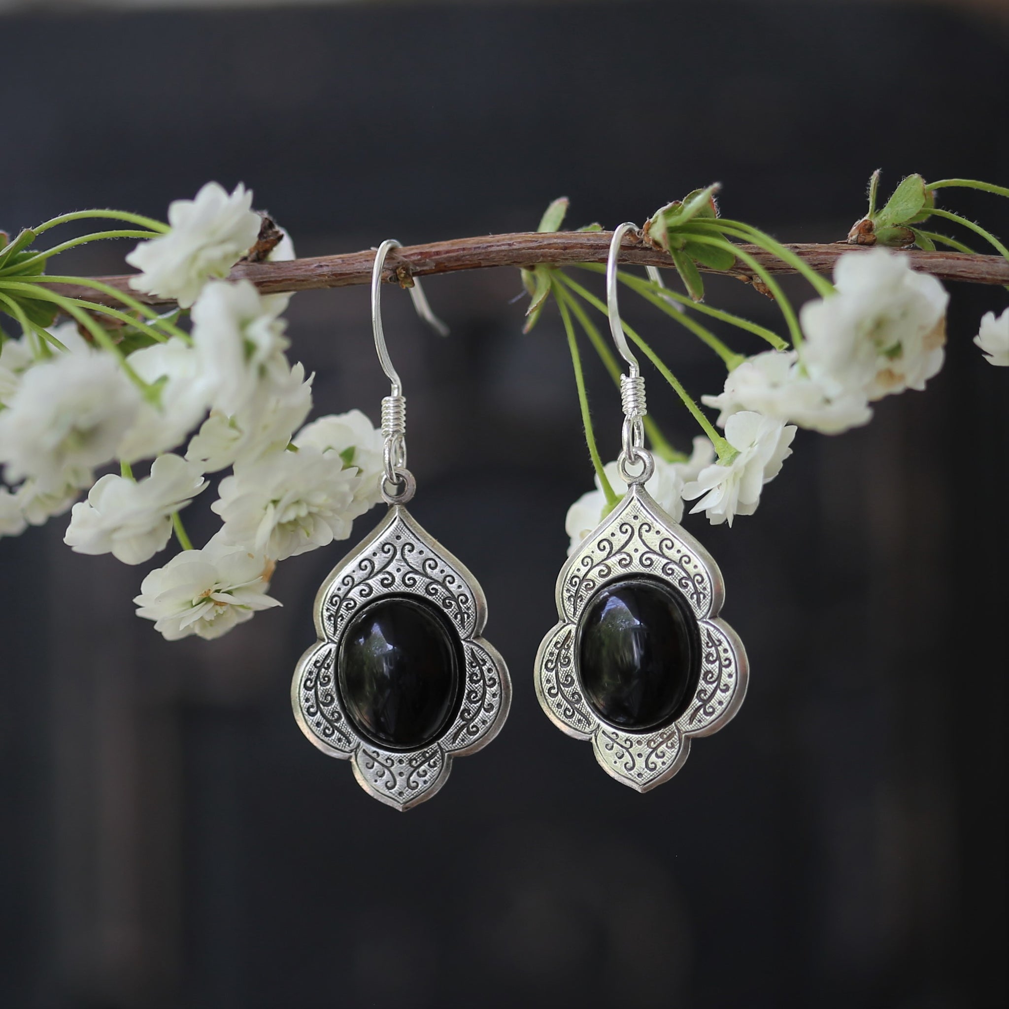 antiqued silver vintage style drop dangle earrings with a leaf and vine motif with semi-precious black onyx mineral oval stone cabochons.