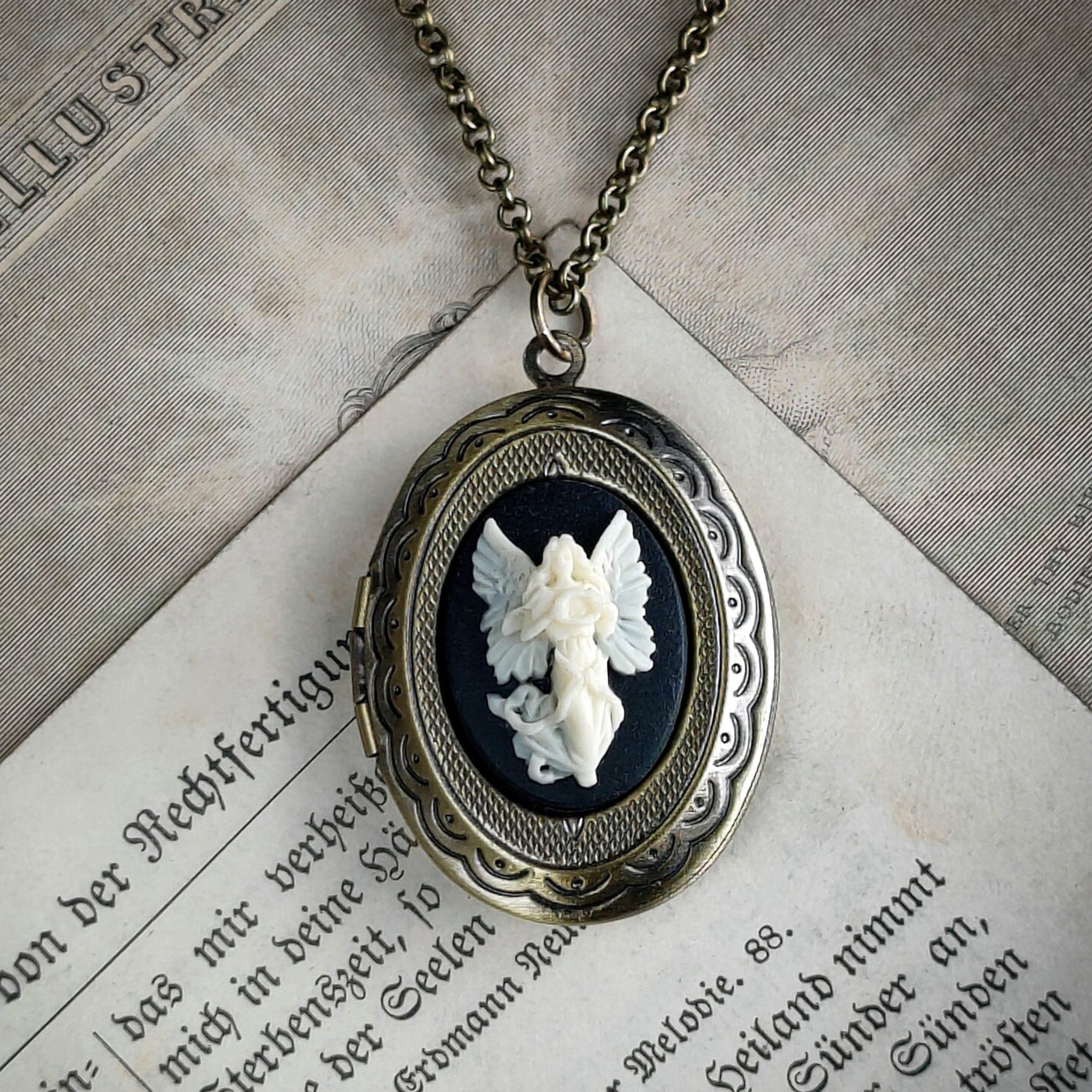 Brass locket necklace with Angel cameo in black and white.