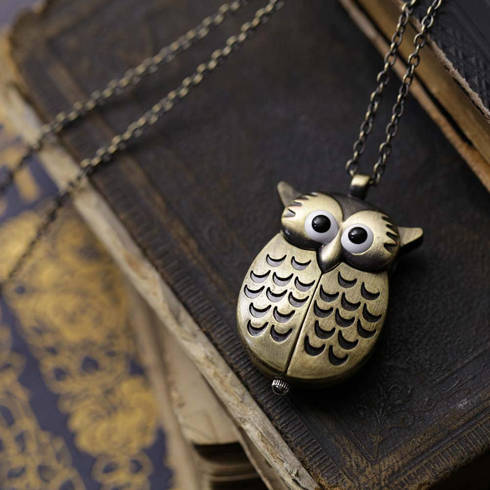 A bronze owl-shaped watch necklace. This watch is closed with the owl's wings covering the watch face.