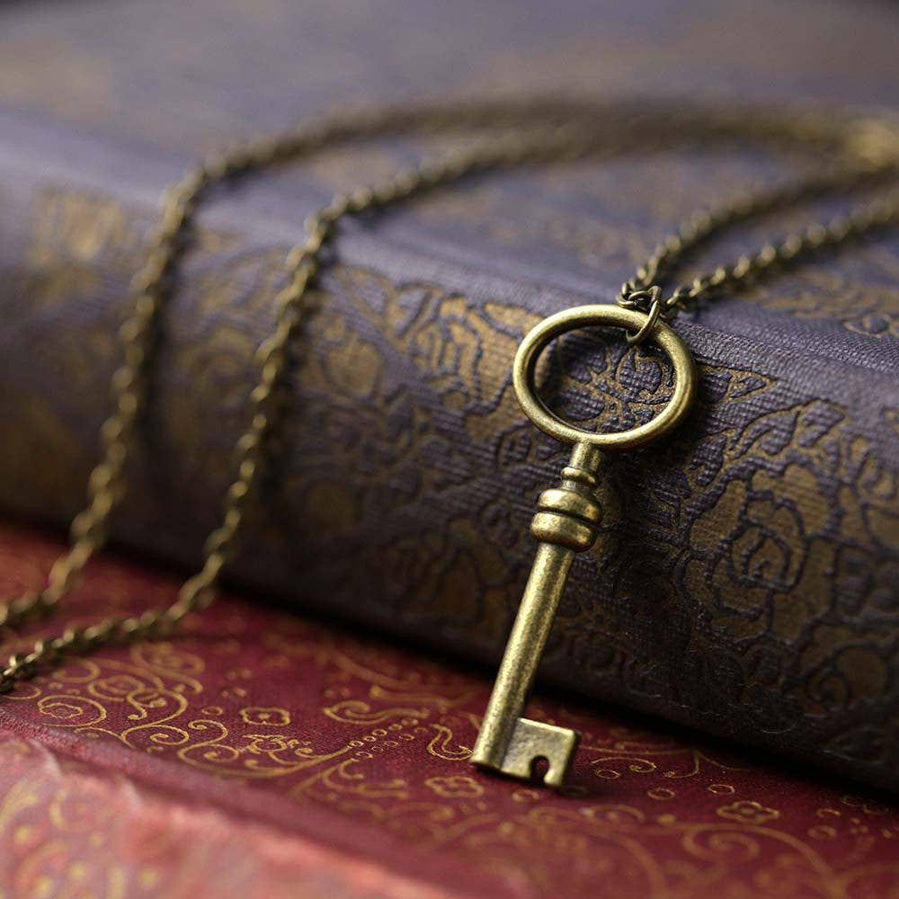 Simple bronze key on a necklace chain.