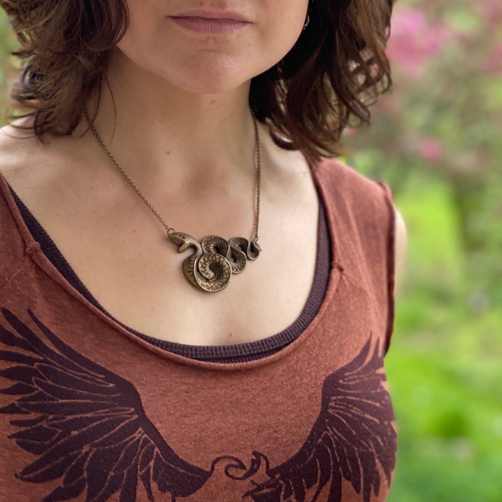 Antiqued brass Victorian snake pendant necklace.