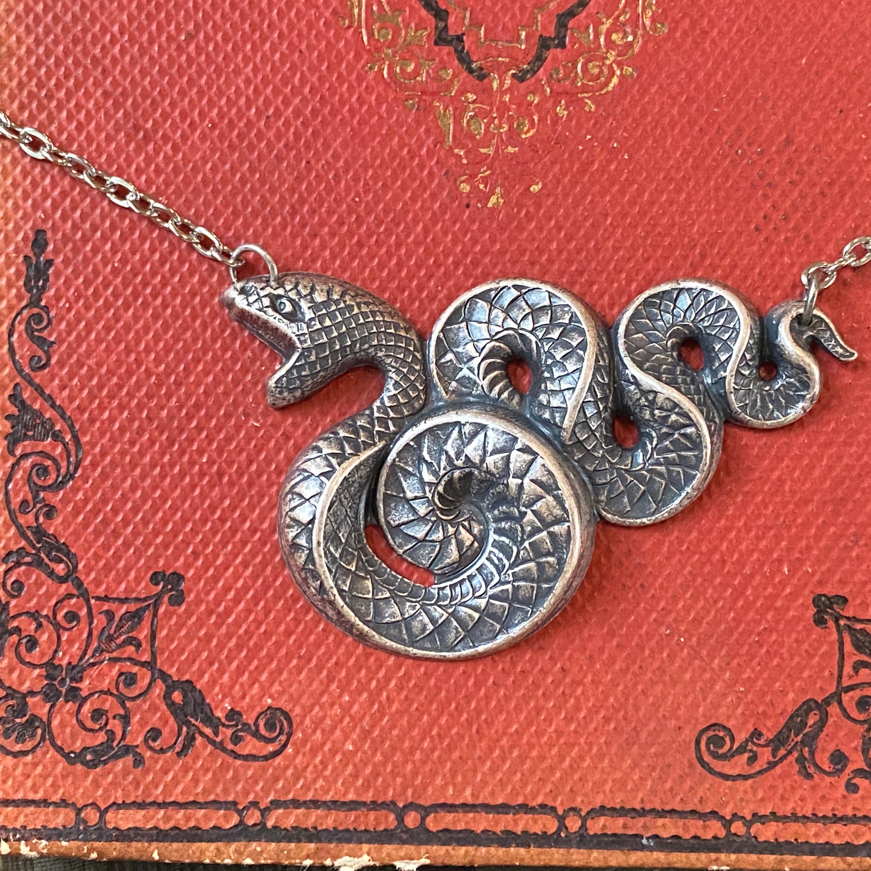 Antiqued brass Victorian snake pendant necklace.