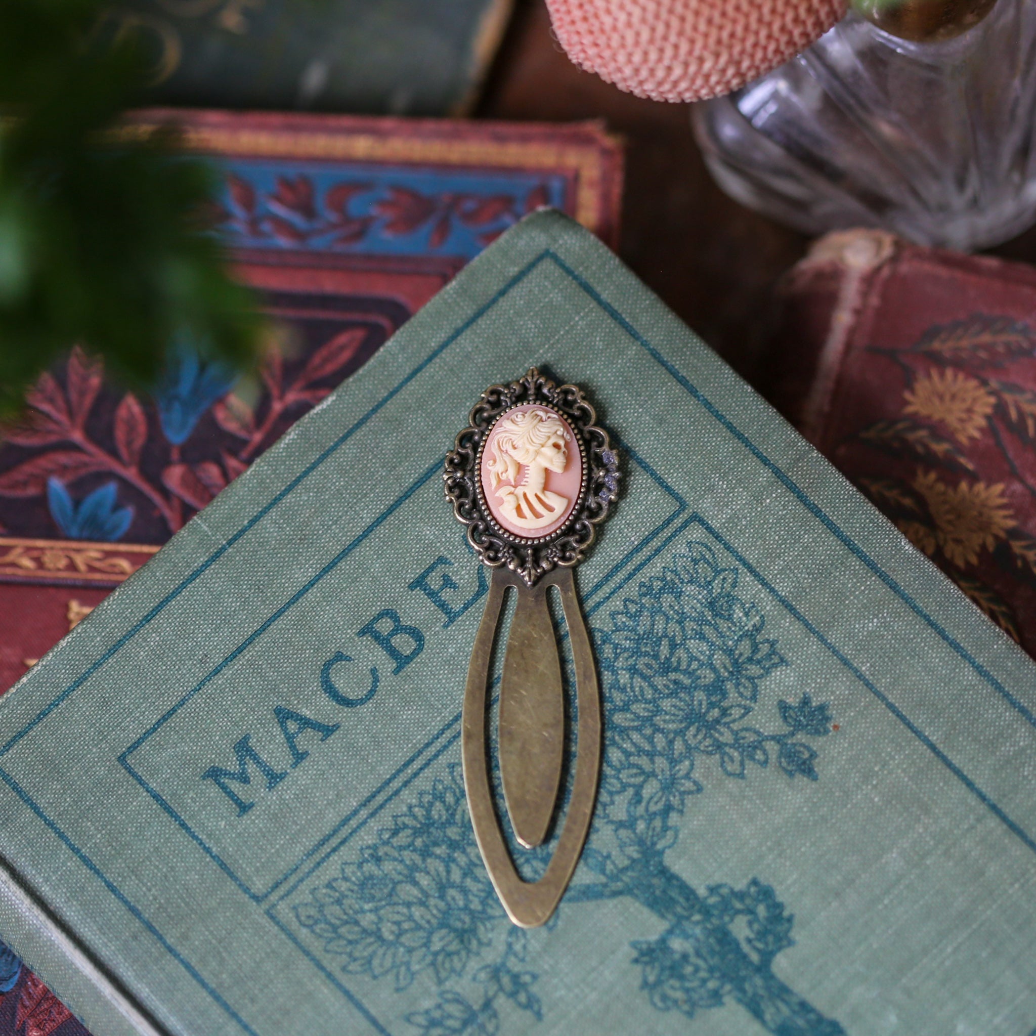 antiqued brass modern vintage inspired clip bookmark page saver with a peach skeleton zombie lady Victorian oval cameo in witchy style