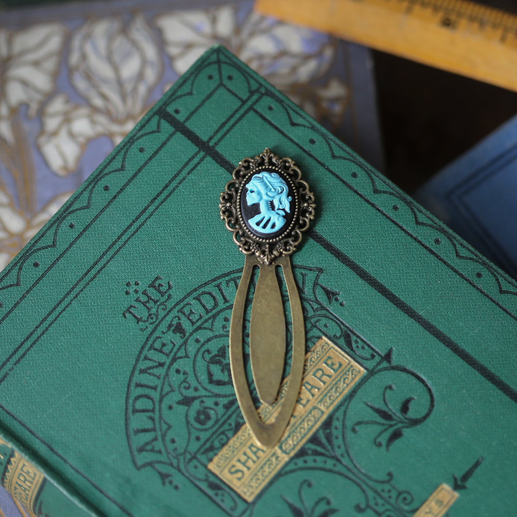 antiqued brass modern vintage inspired clip bookmark page saver with a green skeleton zombie lady Victorian oval cameo gift for fantasy novel reader
