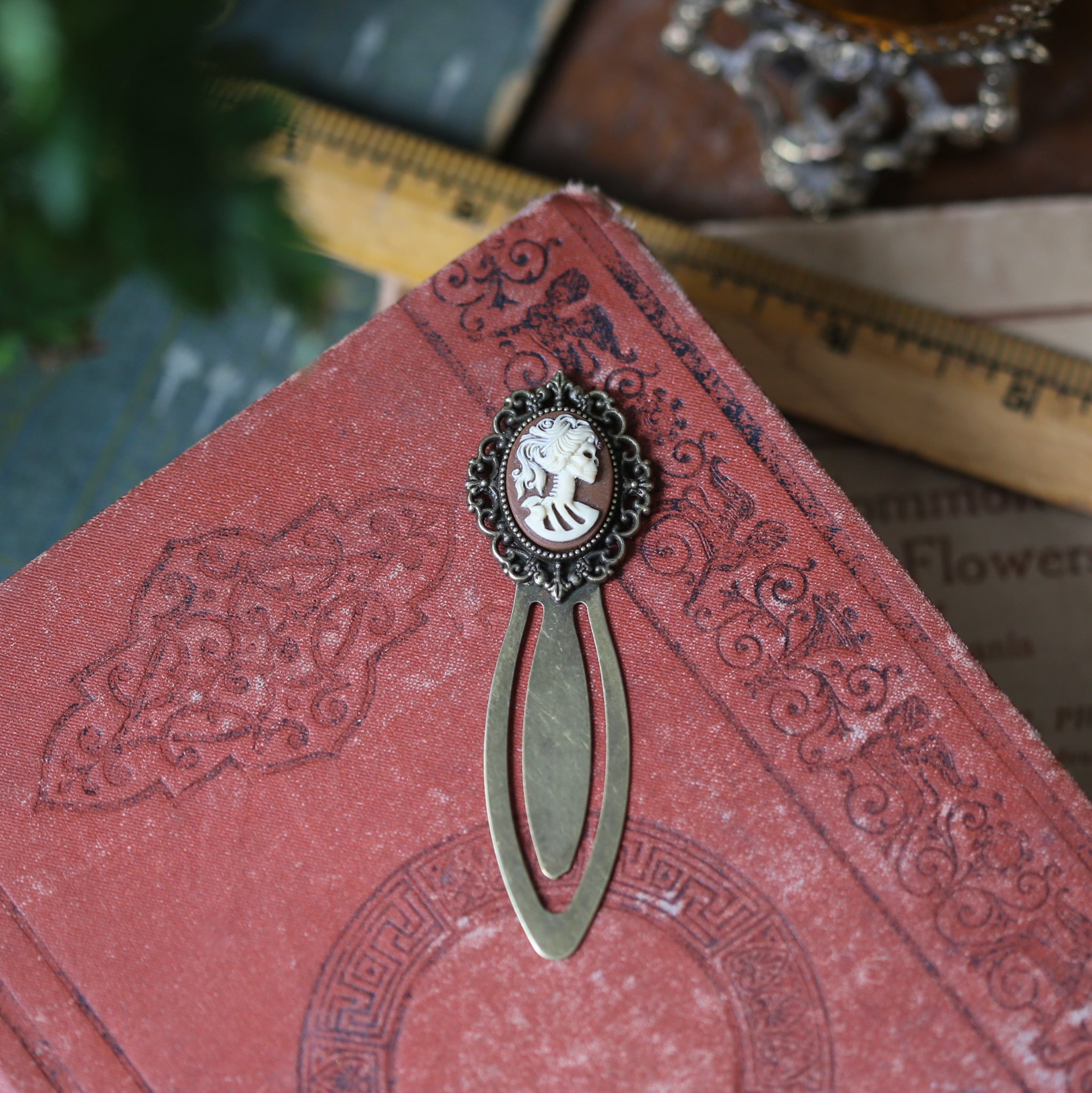 antiqued brass modern vintage inspired clip bookmark page saver with a brown skeleton zombie lady Victorian oval cameo gift for a cuthulu story lover