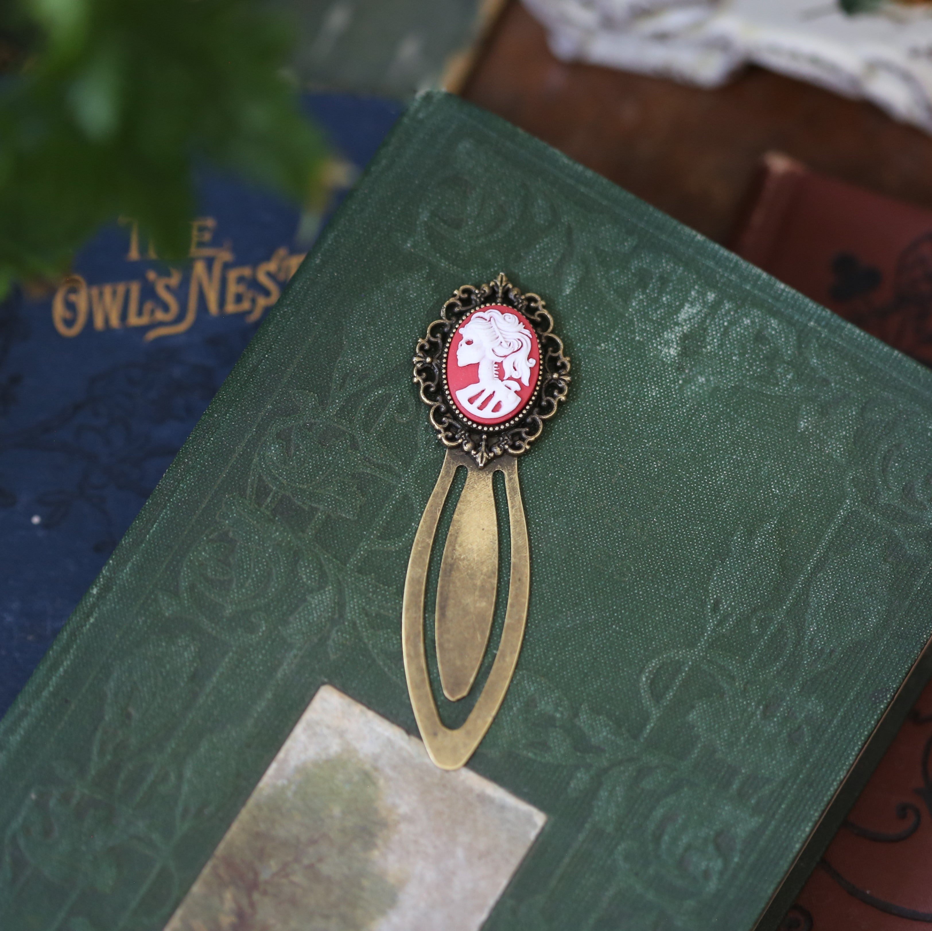 antiqued brass modern vintage inspired clip bookmark page saver with a red skeleton zombie lady Victorian oval cameo for gothic book lover