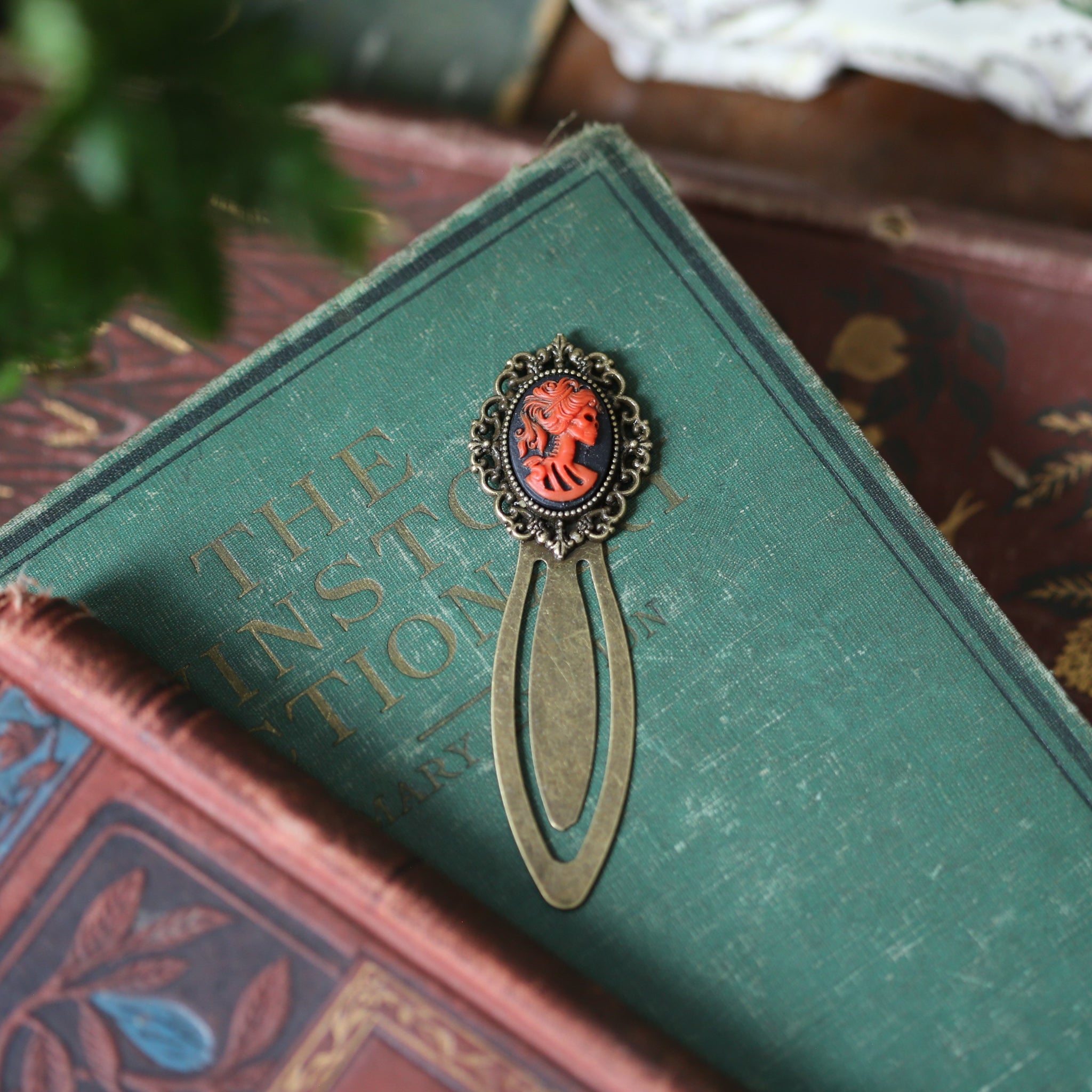 antiqued brass modern vintage inspired clip bookmark page saver with a red skeleton zombie lady Victorian oval cameo in romantic gothic style