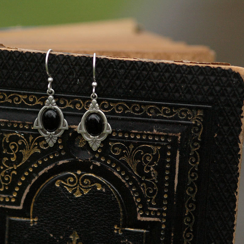 Antiqued silver vintage style art deco dangle earrings with black onyx oval stone set in the center.