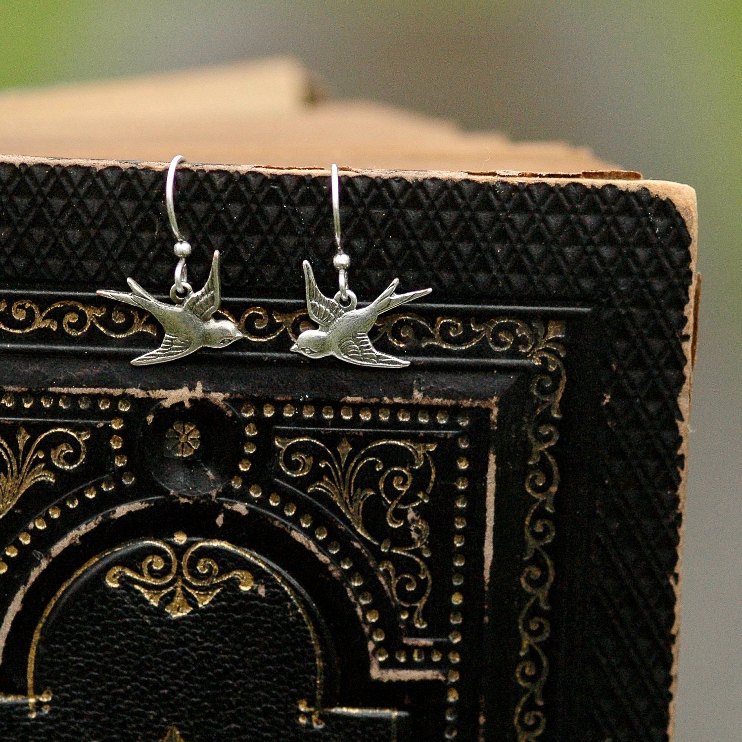 Silver earrings with flying bird charms