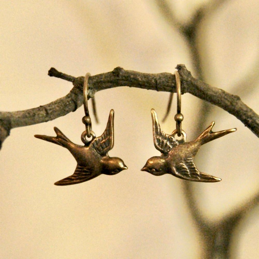 Brass earrings with a flying bird charms