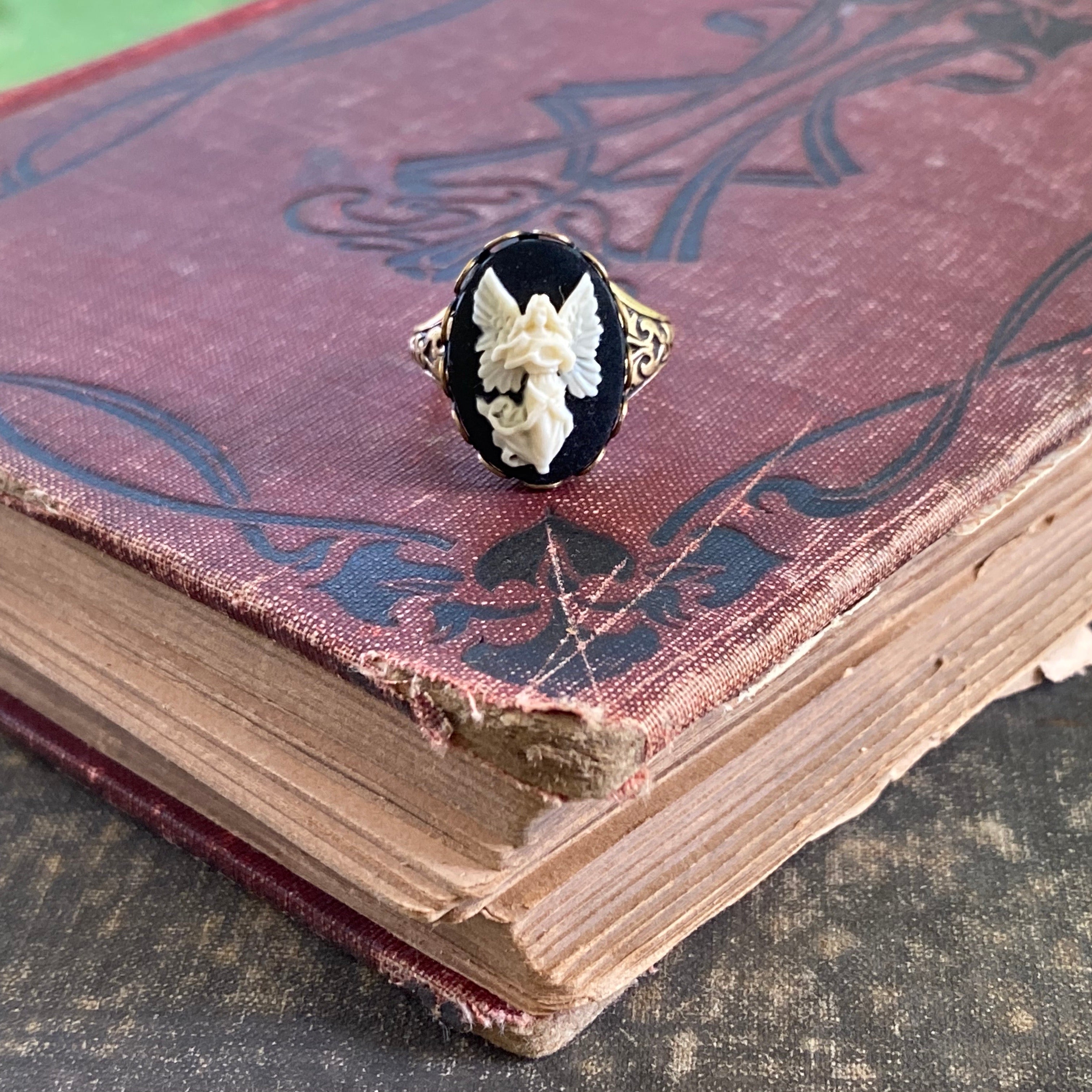 Antiqued brass retro vintage style adjustable ring with black and white angel cameo ring.