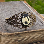 Antiqued brass bronze tone vintage style Victorian adjustable bracelet cuff with a black and white lucky horse and shoe.cameo.