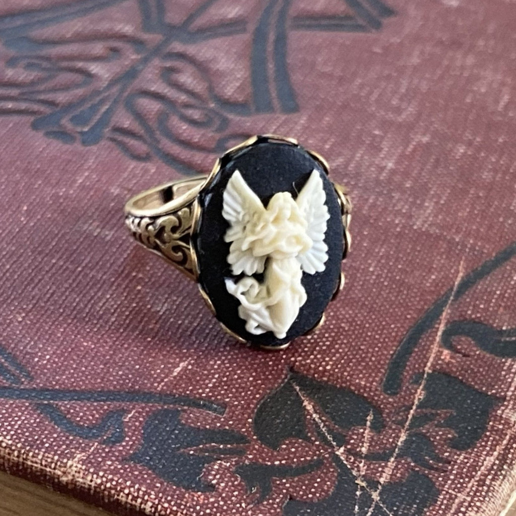 Antiqued brass retro vintage style adjustable ring with black and white angel cameo ring.