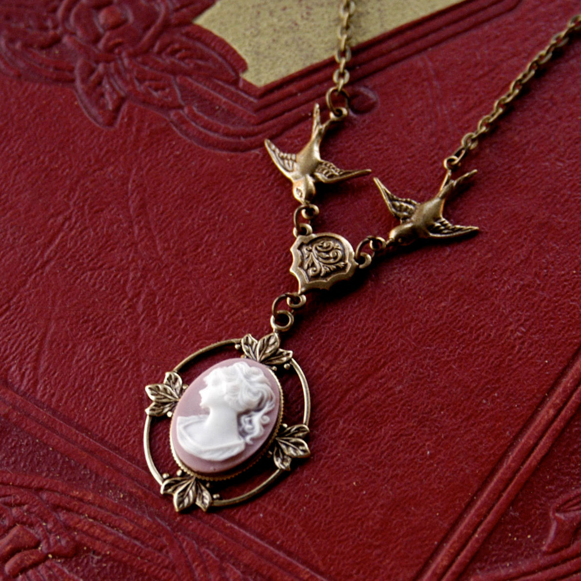 Antiqued brass Victorian lady white on pink cameo necklace on a chain with birds.