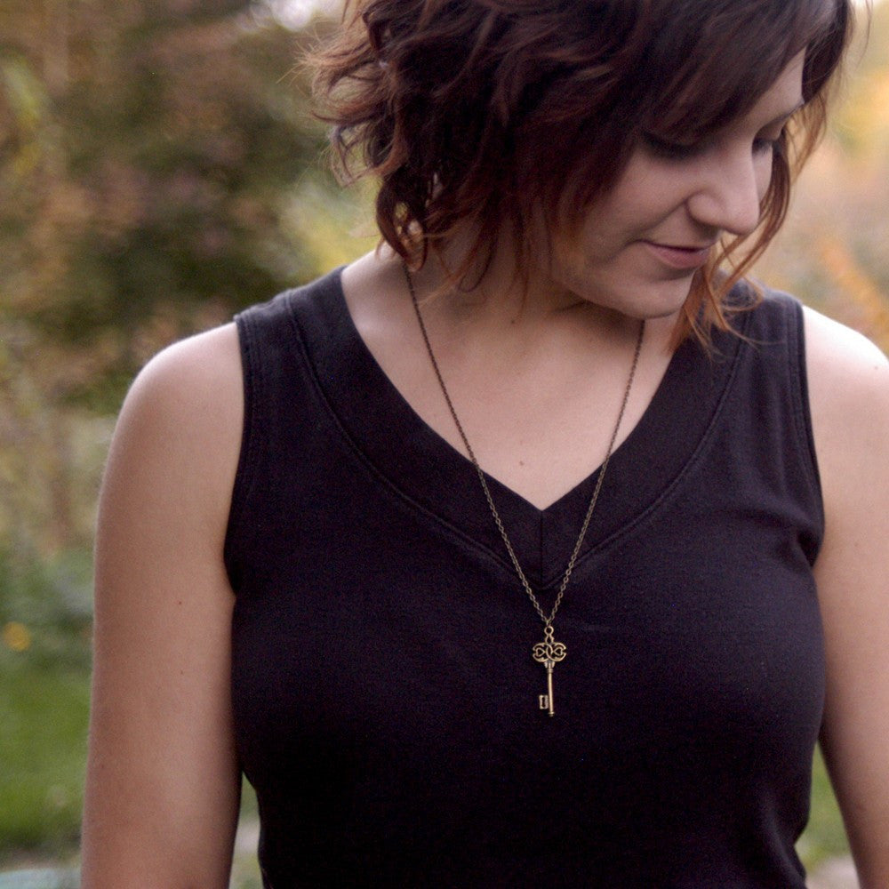 Antiqued brass infinity and hearts key pendant.