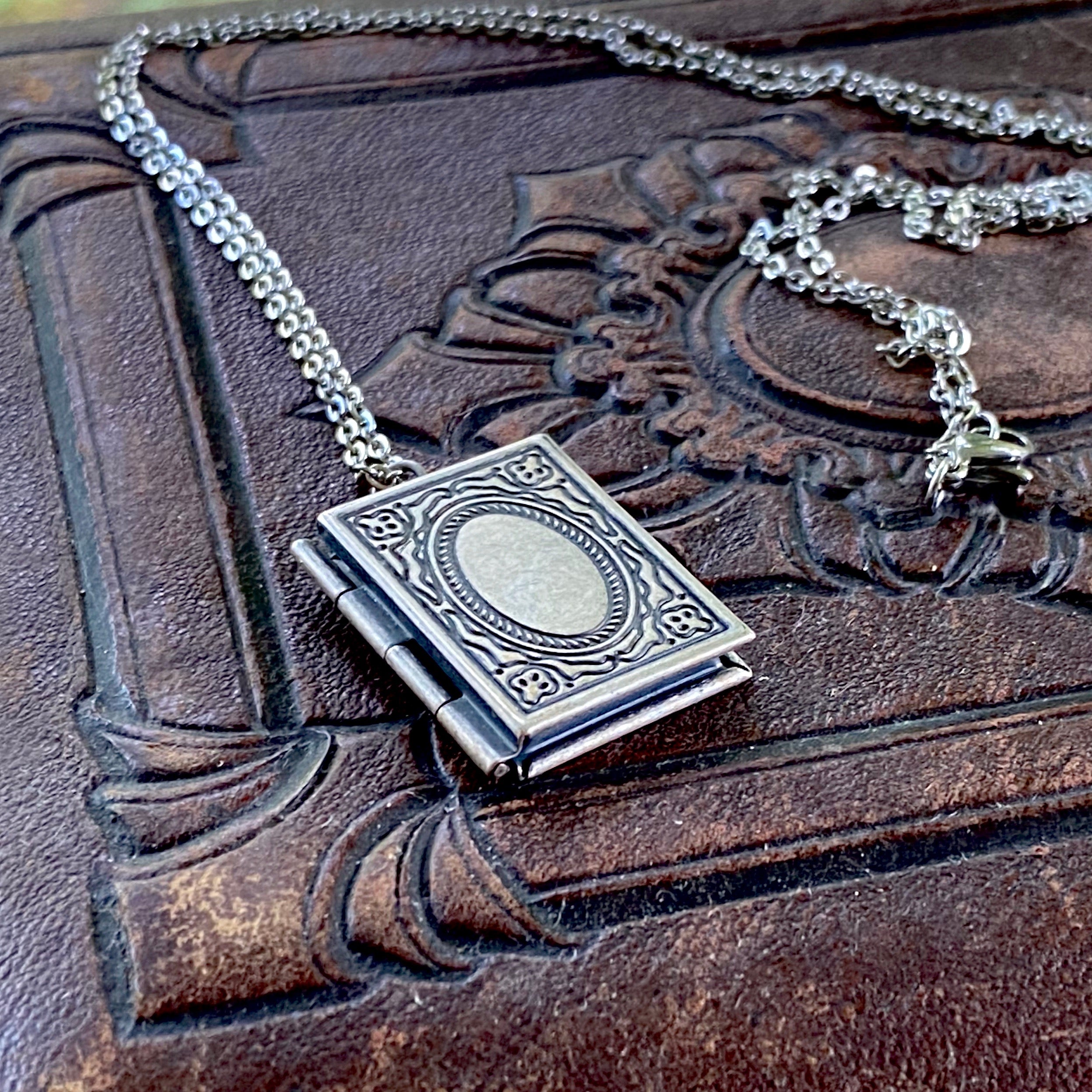 Antiqued silver necklace with a book-shaped locket.