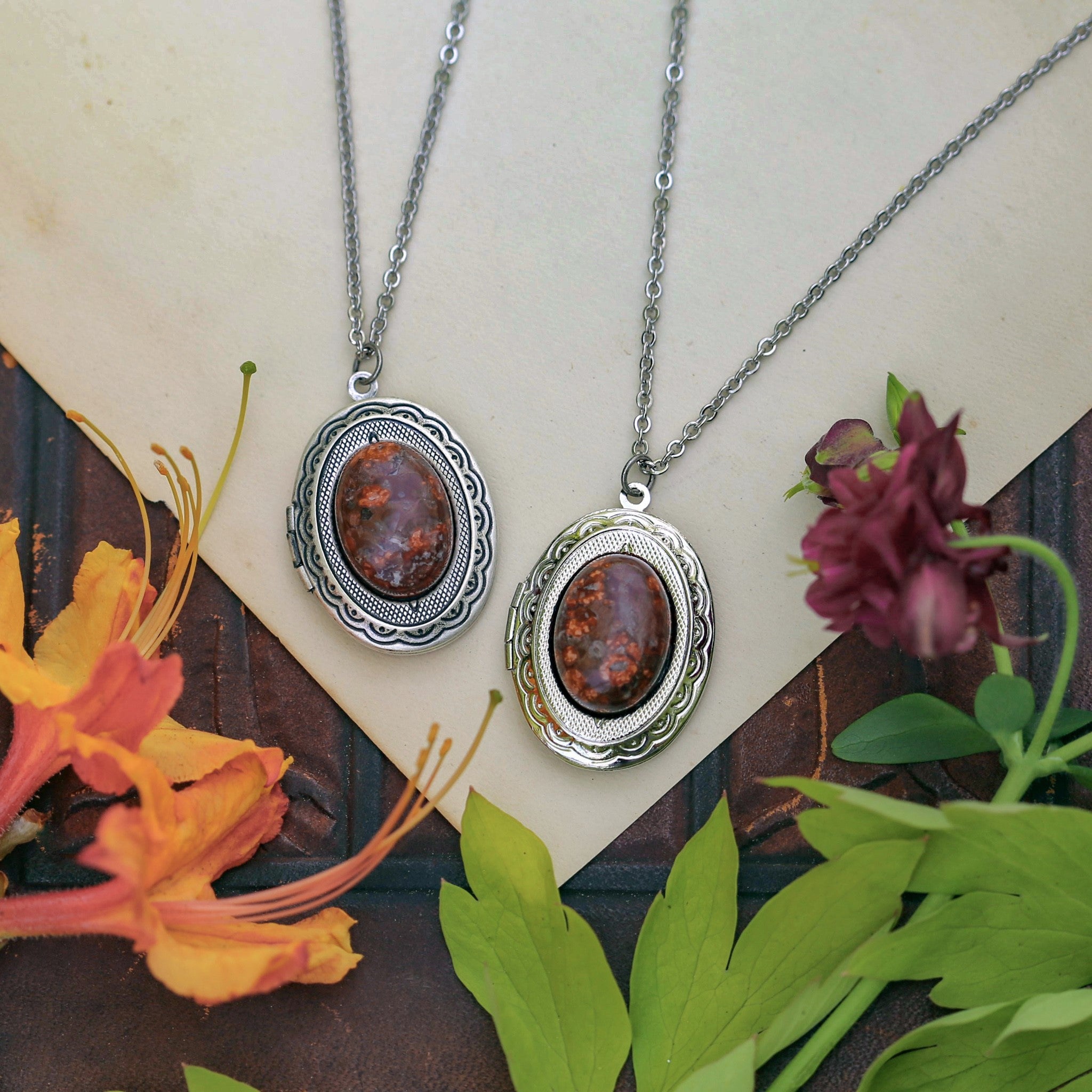 Antiqued silver timeless long oval orange mottled leopardskin jasper semi-precious stone mineral locket in bold autumnal art academia style making a great thoughtful gift for your loved one.