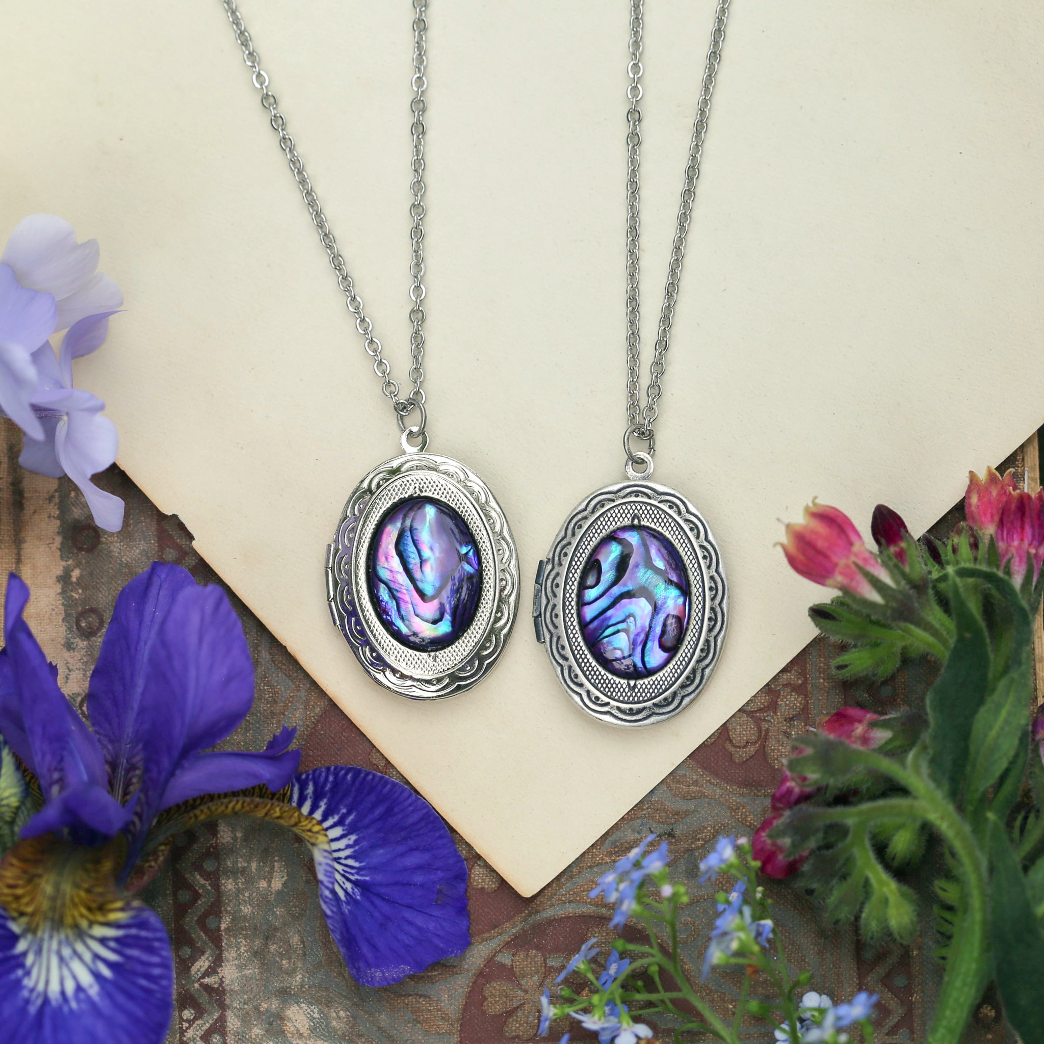 antiqued silver vintage style oval locket with a purple seashell cabochon in beach day aesthetic a thoughtful gift for an ocean lover