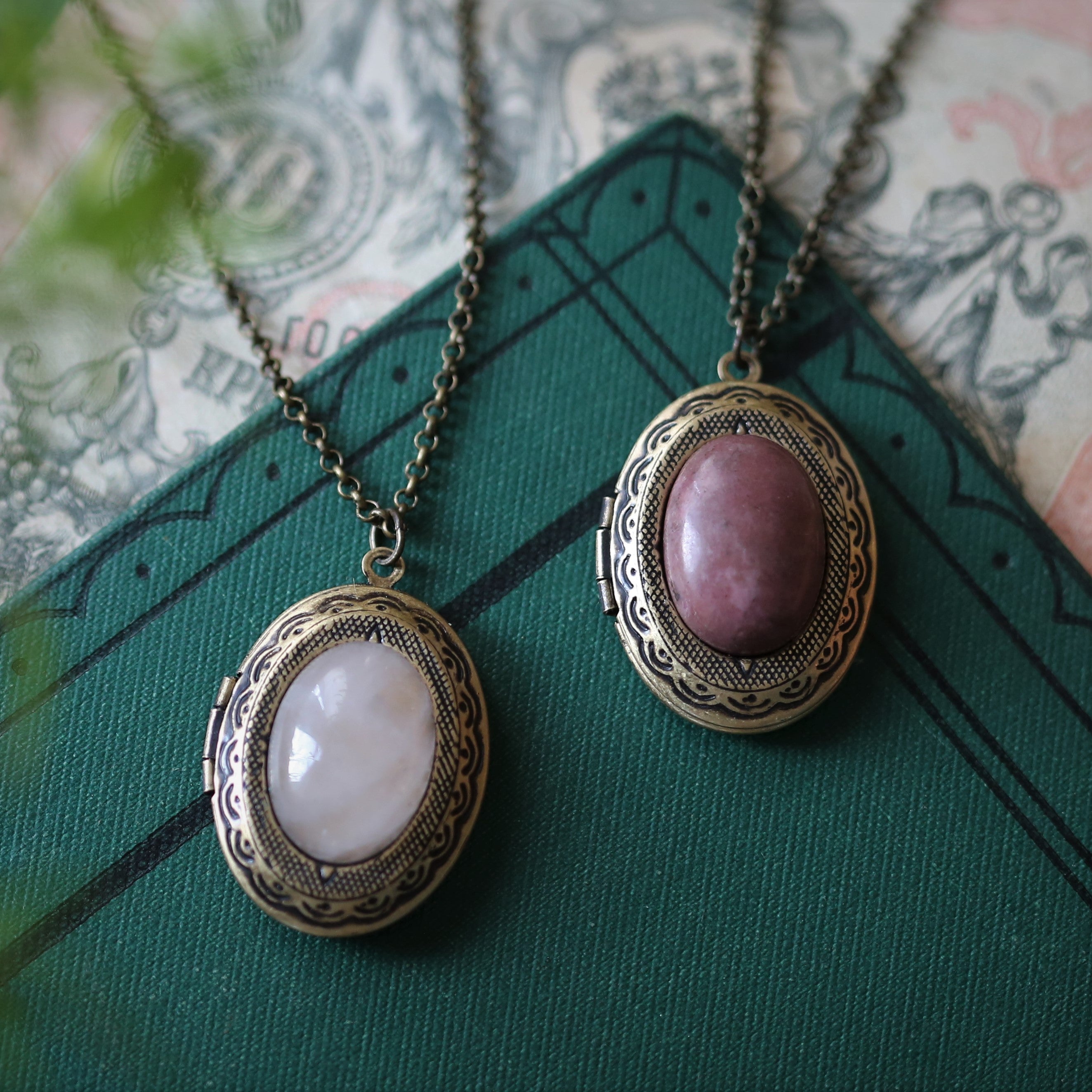 antiqued brass modern vintage style oval locket with a pink rhodonite or rose quartz in the barbiecore style