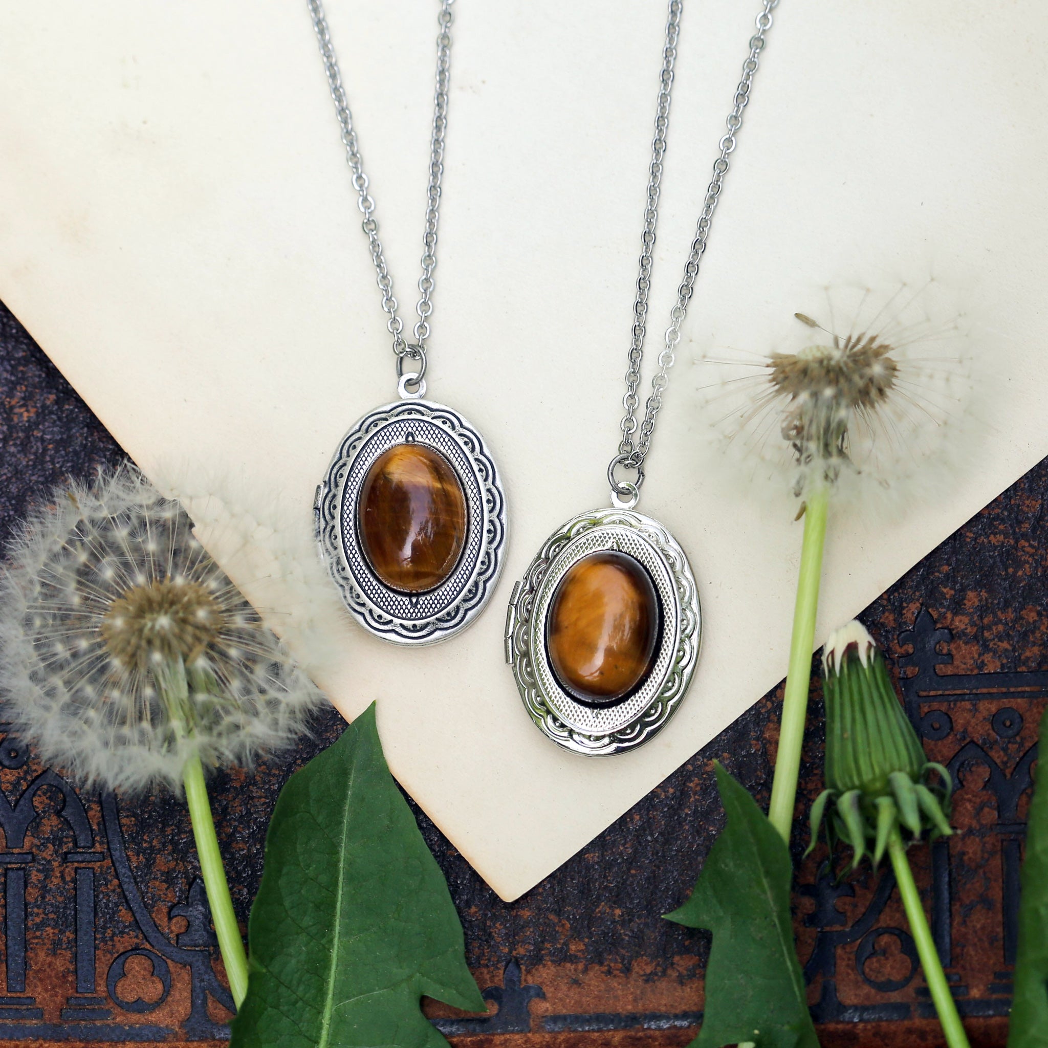 Antiqued silver classic age old long oval brown tiger eye semi-precious stone mineral locket in bold autumnal art academia style making a great sentimental gift for your loved one.