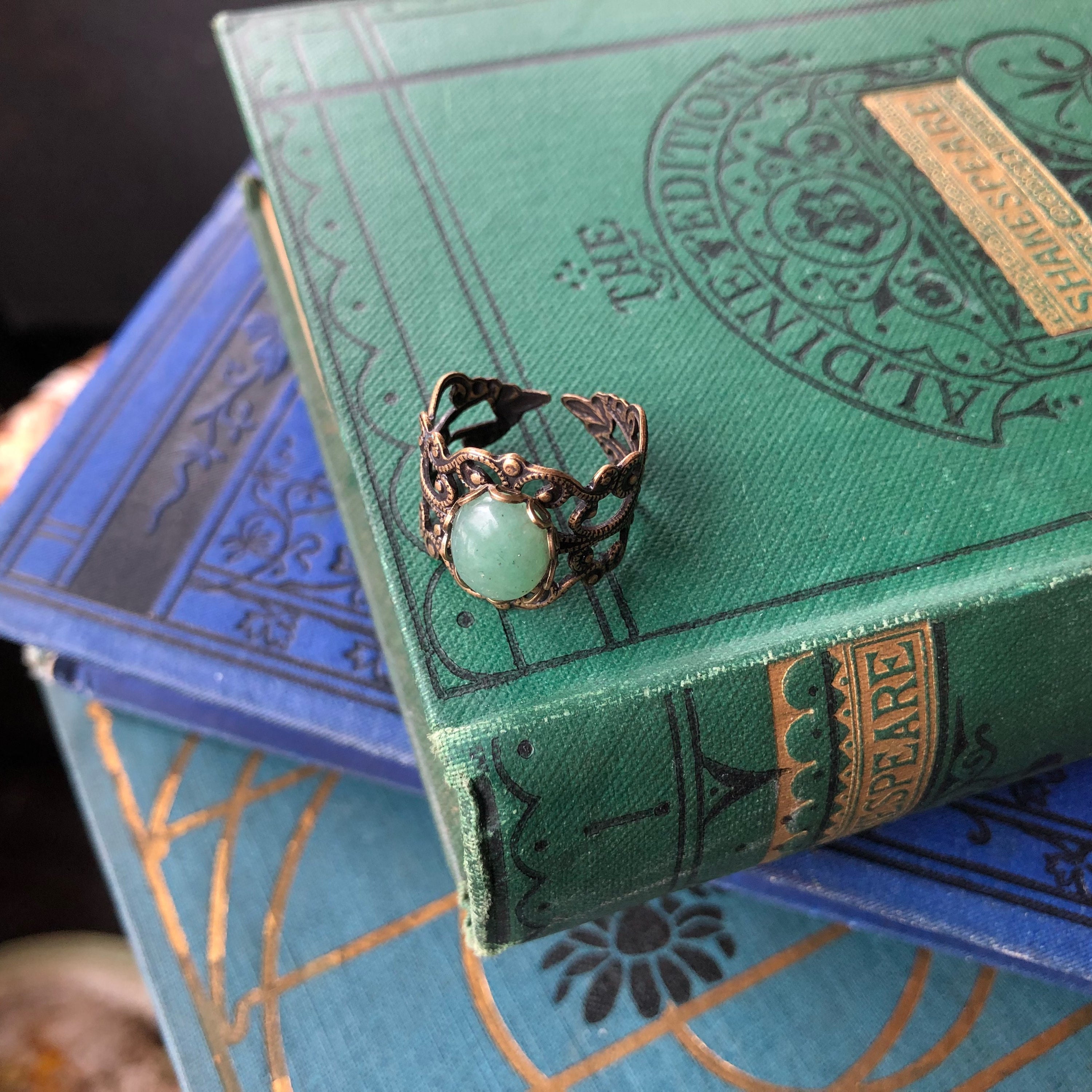Antiqued brass modern vintage inspired adjustable filigree cocktail ring with a green aventurine semi-precious stone in the autumn academia style.