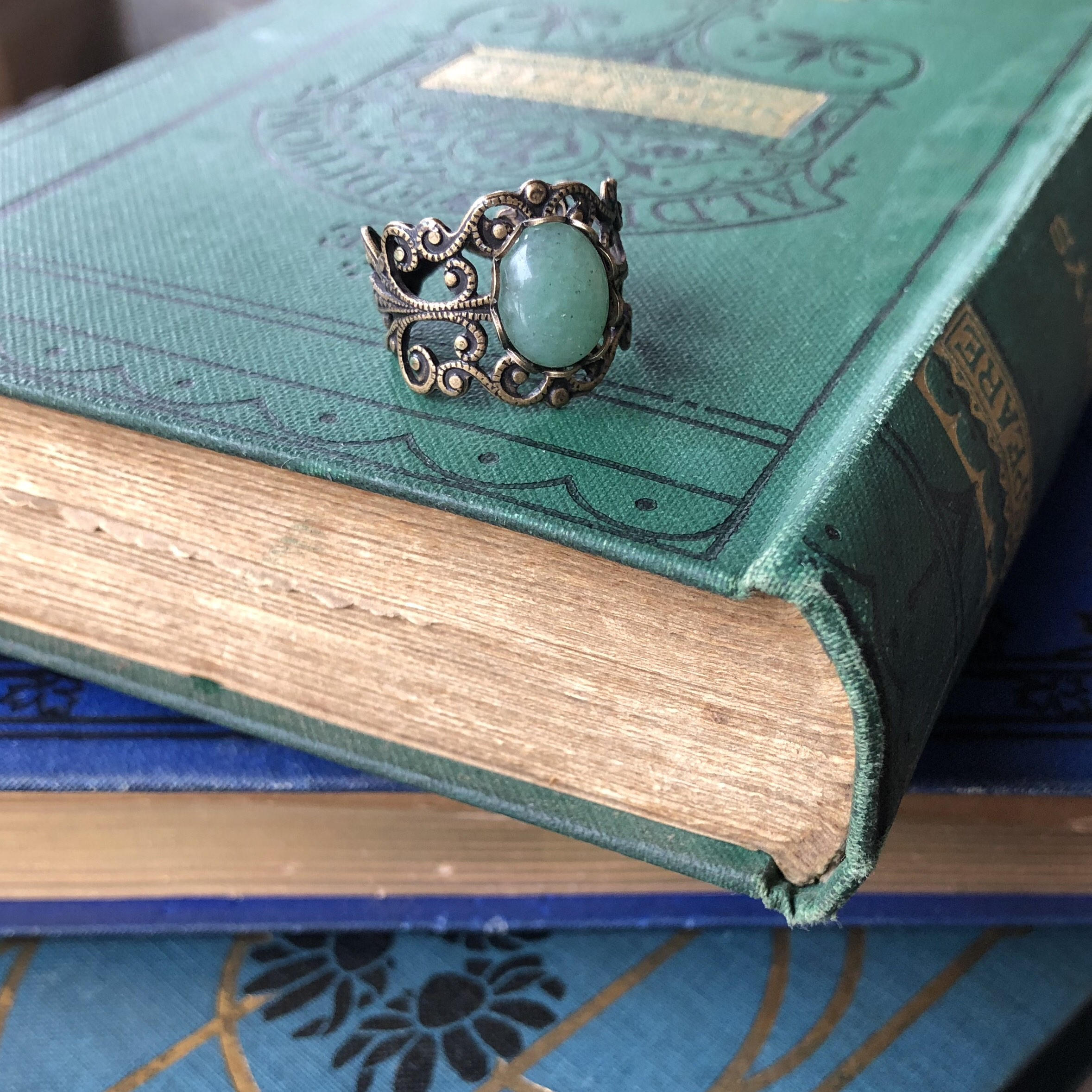 Antiqued brass modern vintage inspired adjustable filigree cocktail ring with a green aventurine semi-precious stone in the cottagecore style.