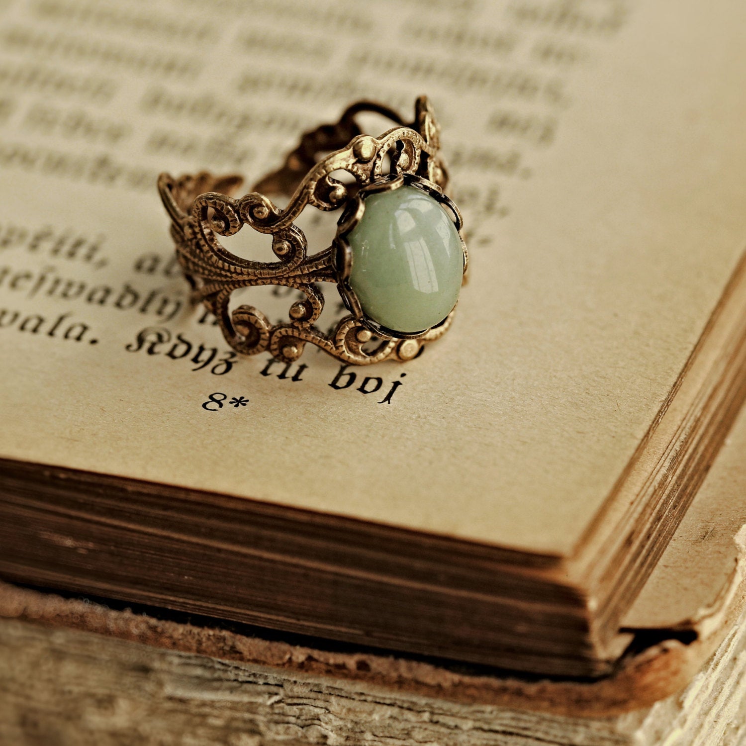 Antiqued brass modern vintage inspired adjustable filigree cocktail ring with a green aventurine semi-precious stone in the clean girl style.